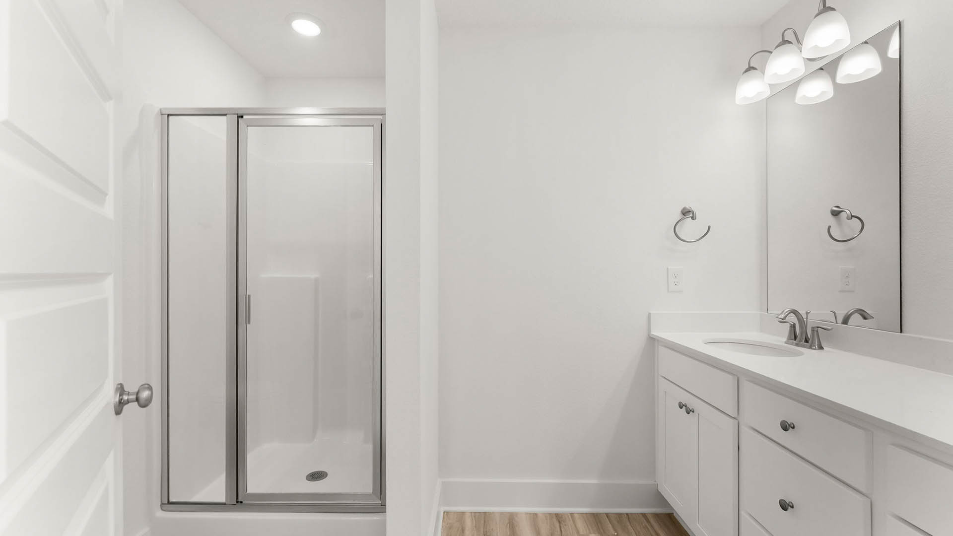 The primary bathroom has a shower with glass enclosure