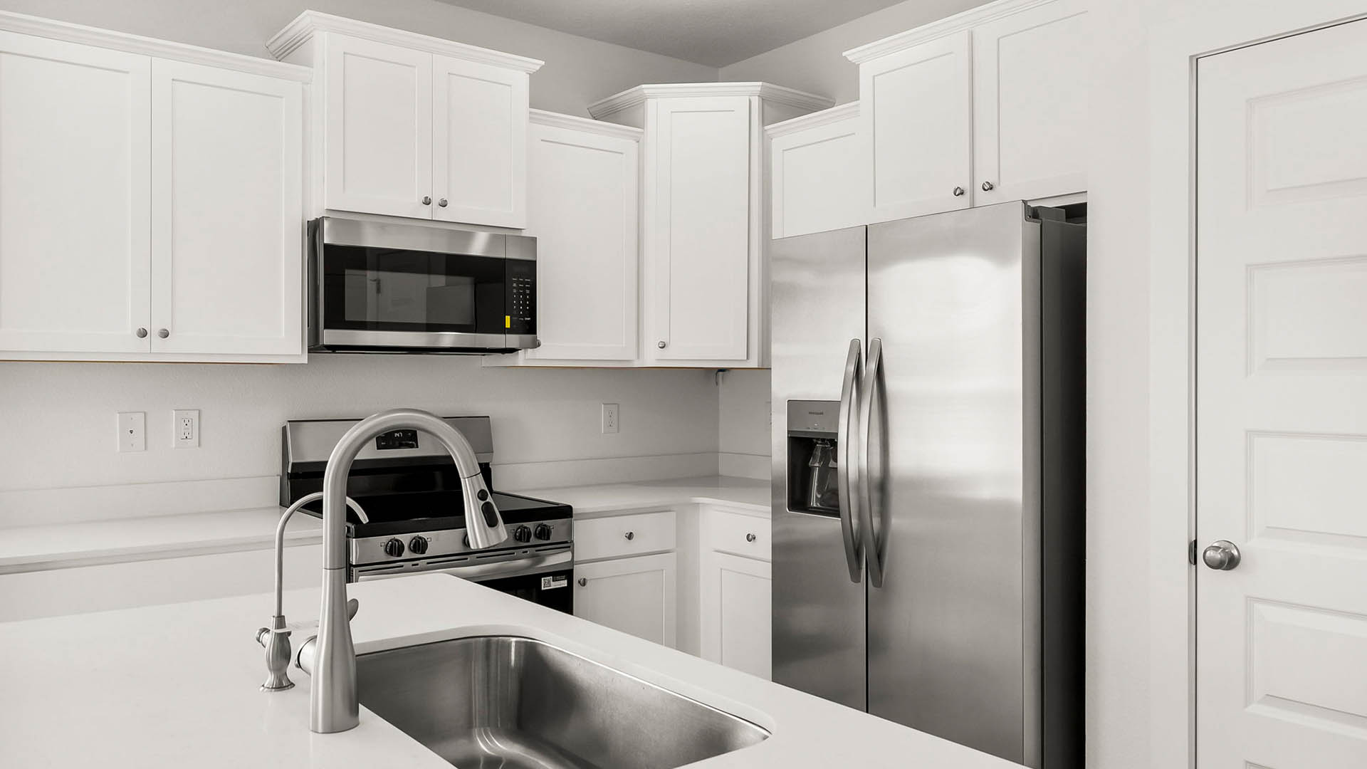 The kitchen has upper and lower cabinetry