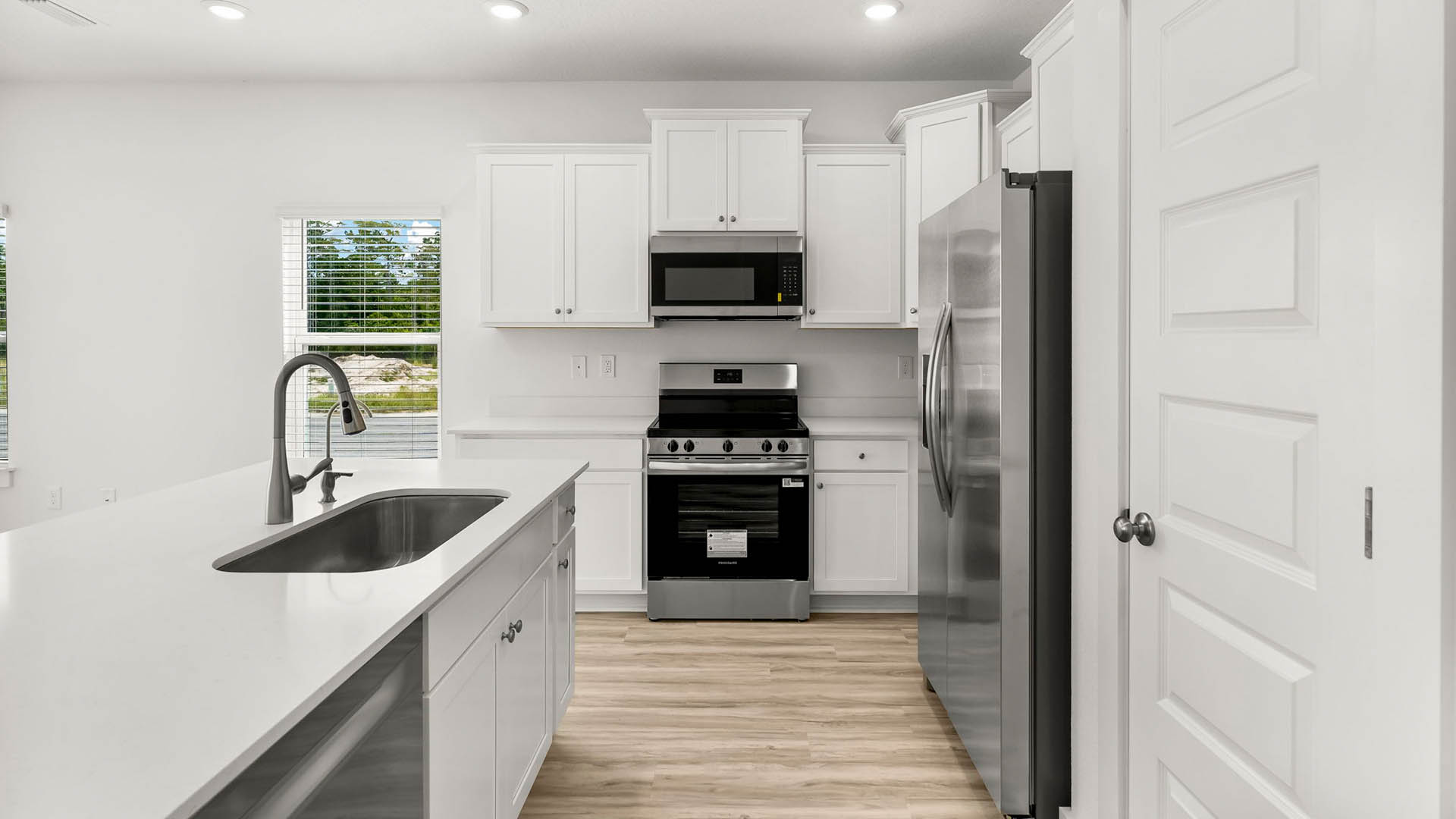 The kitchen has upper and lower cabinetry