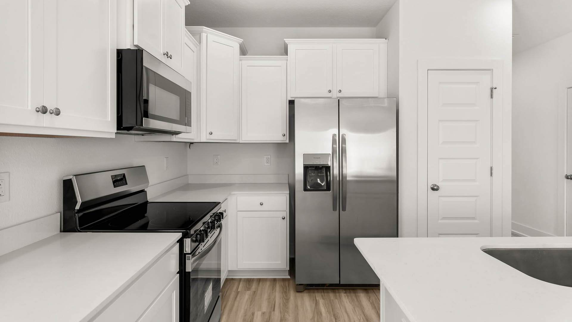 The kitchen island has a dishwasher and sink for easy meal prep and clean up