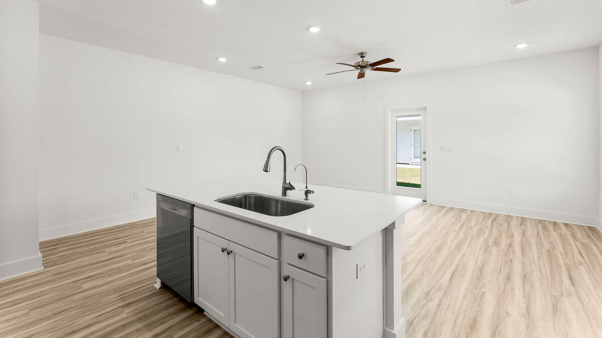 The kitchen island has a dishwasher and sink for easy meal prep and clean up