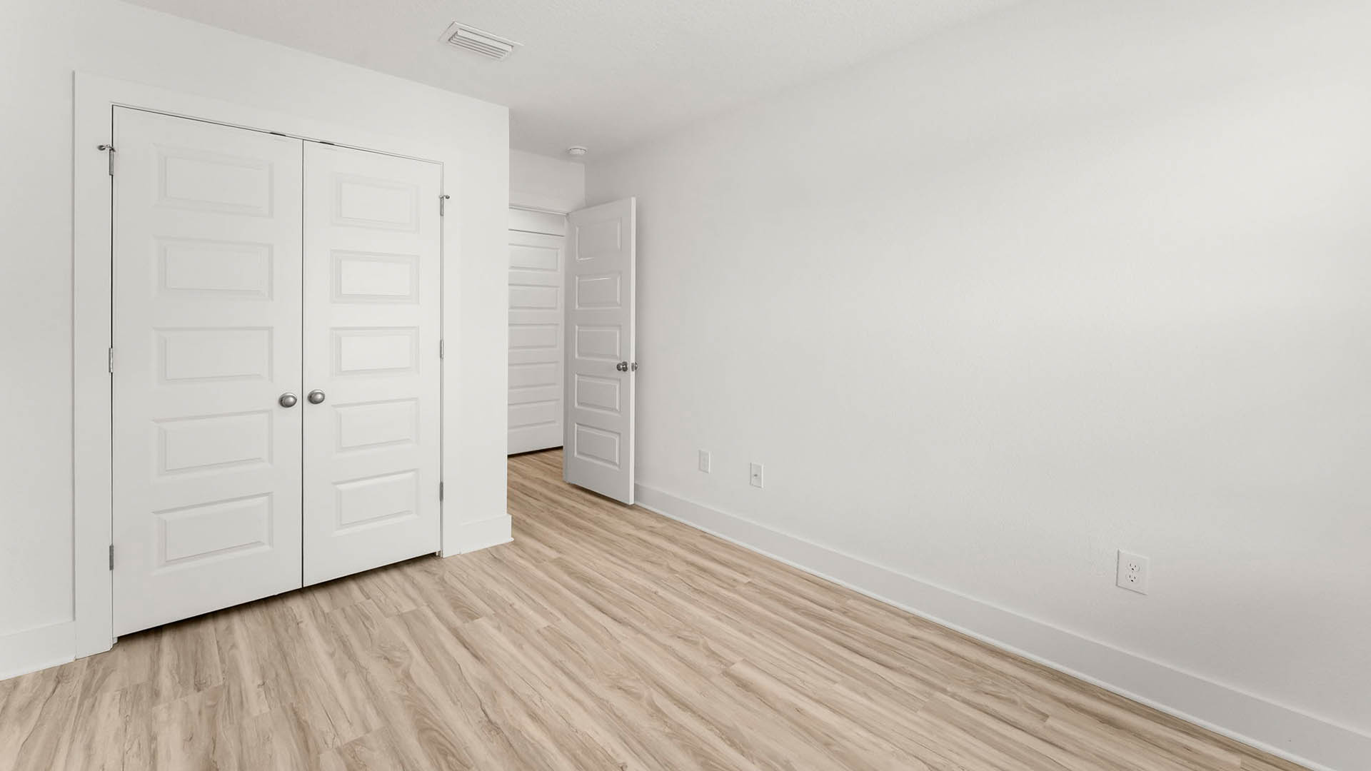 Additional bedroom one has EVP flooring