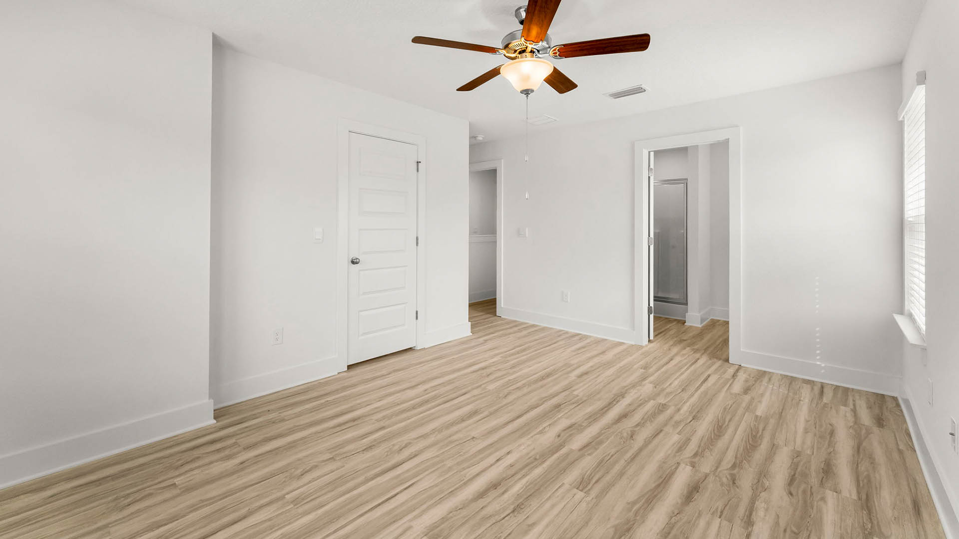 The primary bedroom has a ceiling fan and a spacious closet