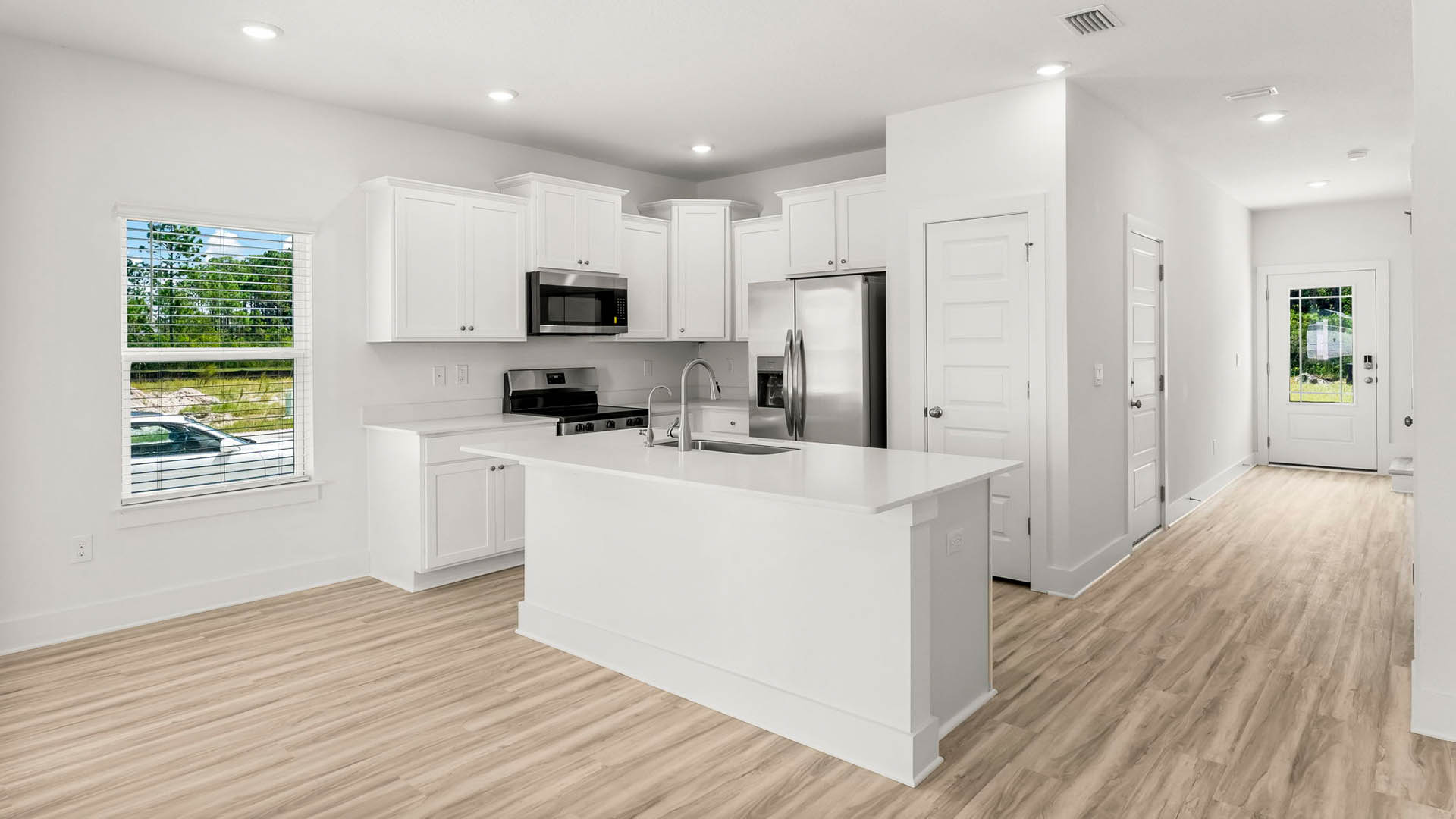 The kitchen has a center island with space for seating