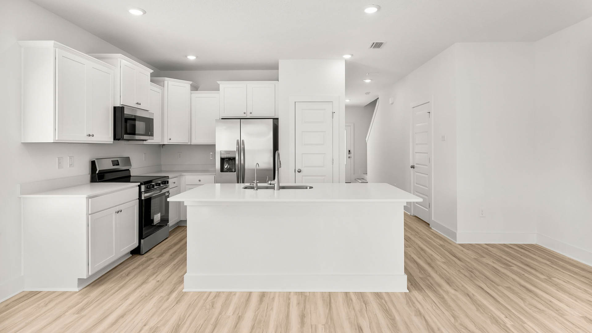 The kitchen is open to the living and dining areas