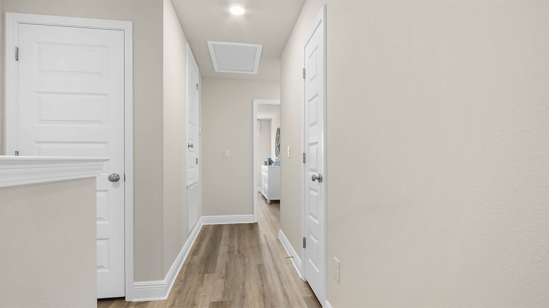 Upstairs foyer with EVP flooring and hallway with linen closet.