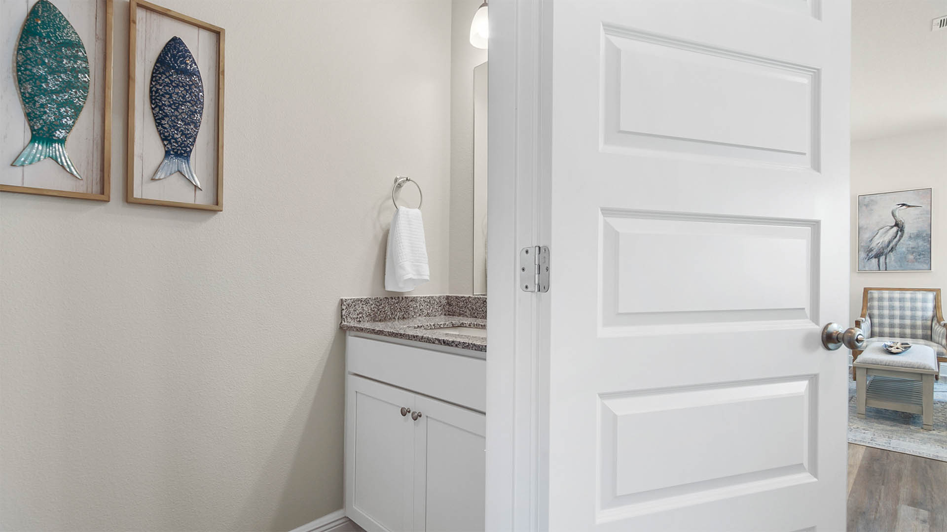 Entrance to half bathroom in hallway to living area.