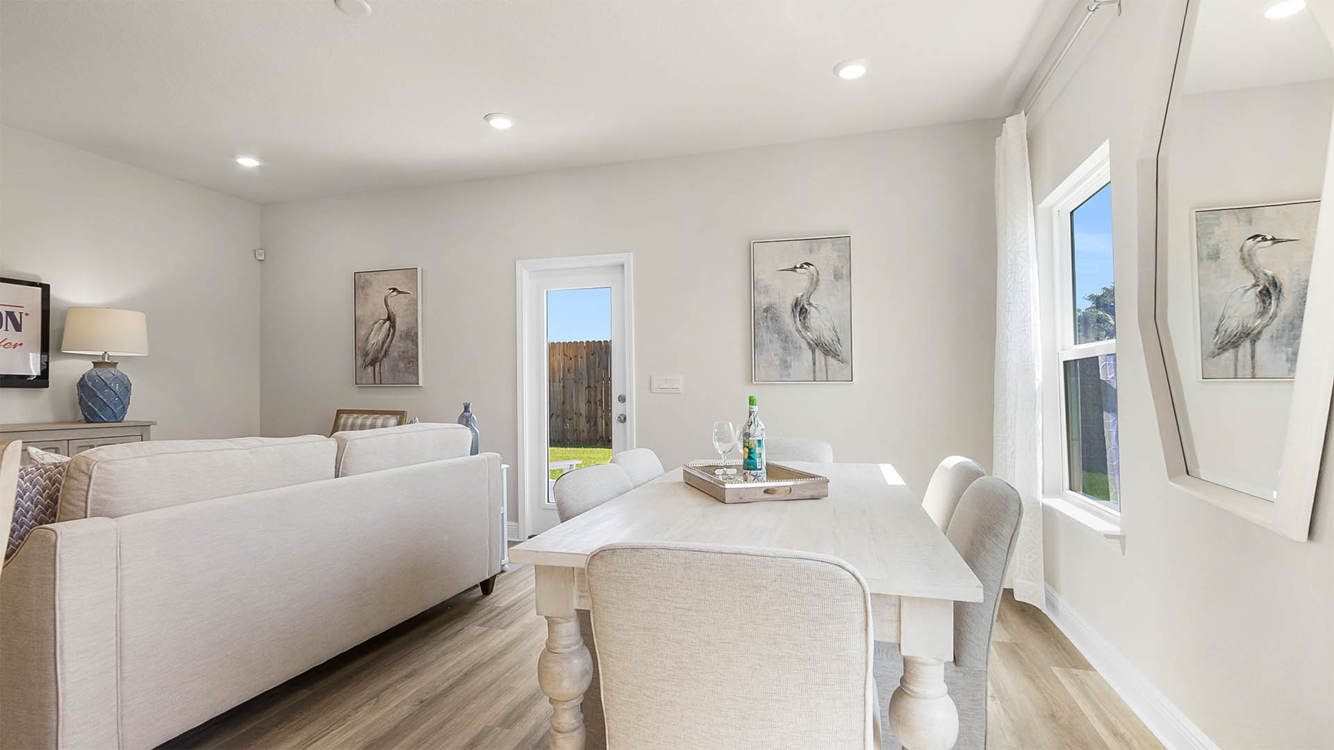 Dining room and living room with two windows and glass back door and EVP flooring.