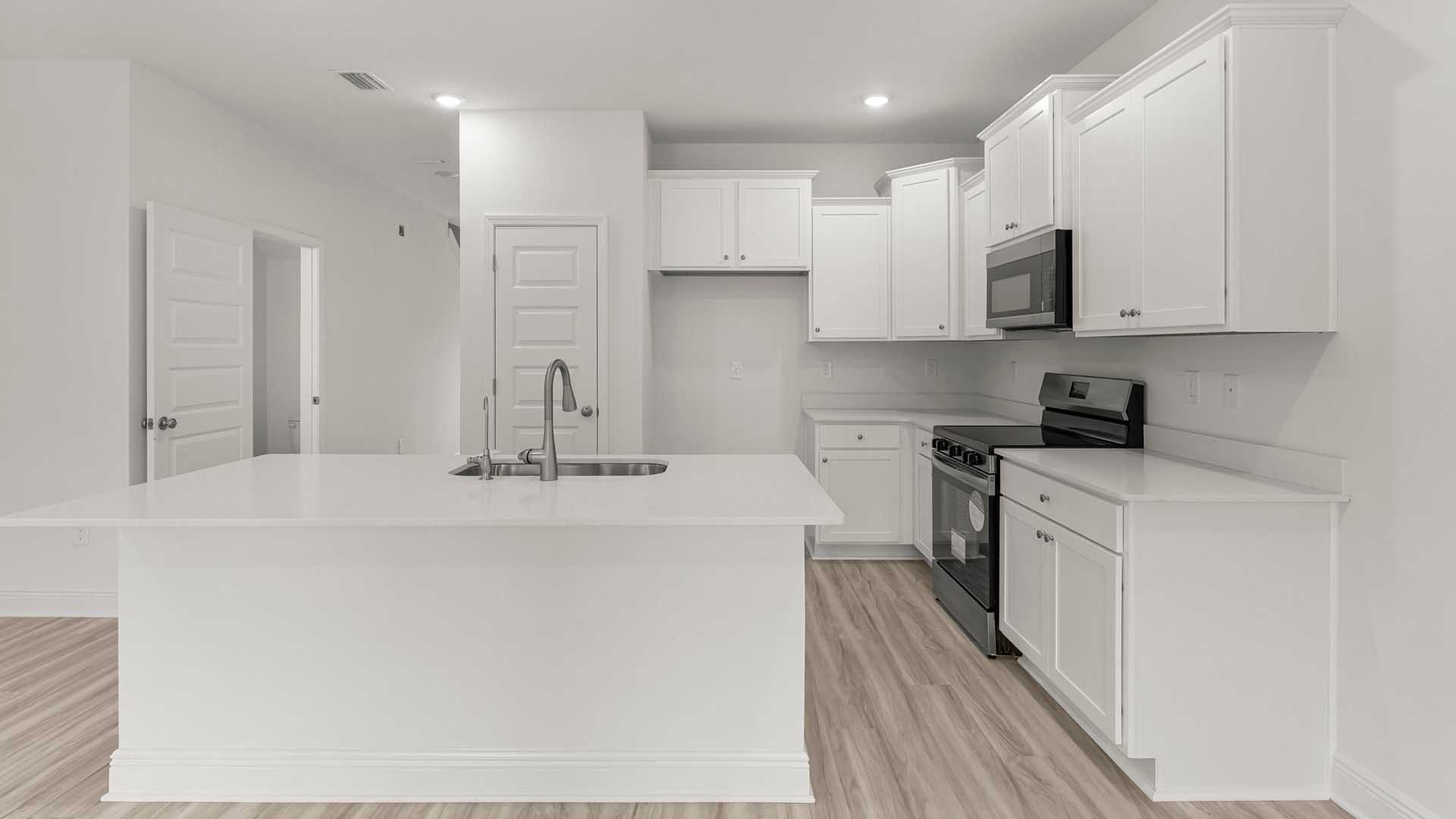 Beautiful white cabinetry surrounds the spacious kitchen