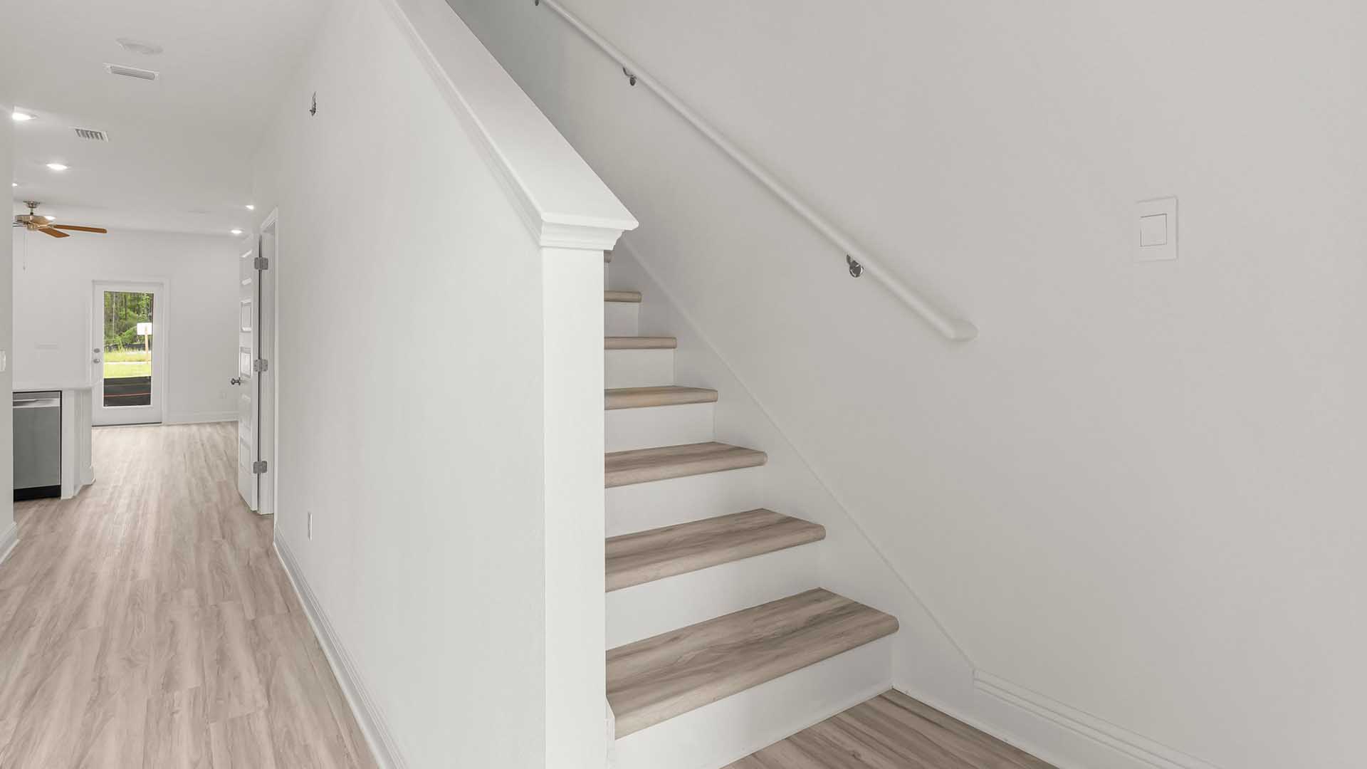 Entry hall with stairs features EVP flooring