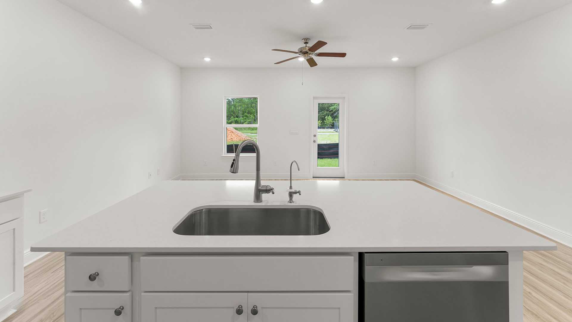 The center island of the sink has beautiful quartz countertops