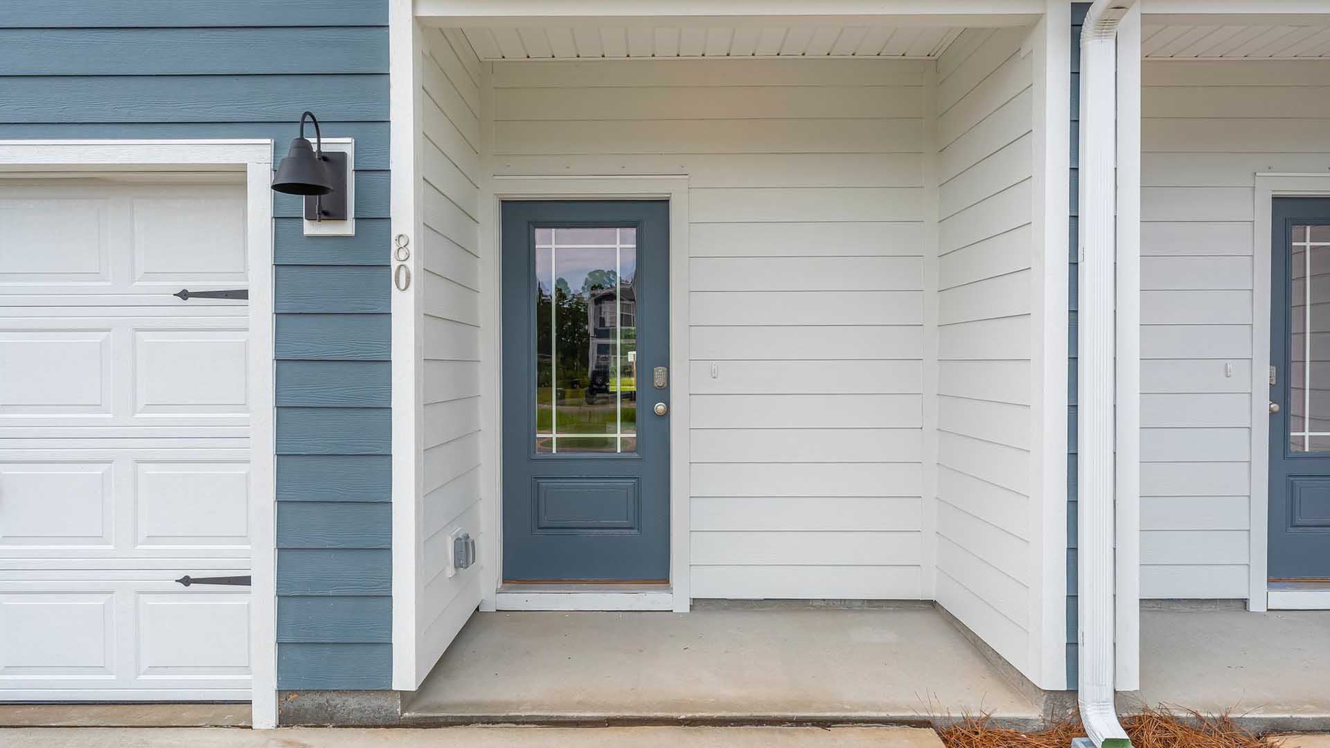 Entry to the townhome has a glass front door