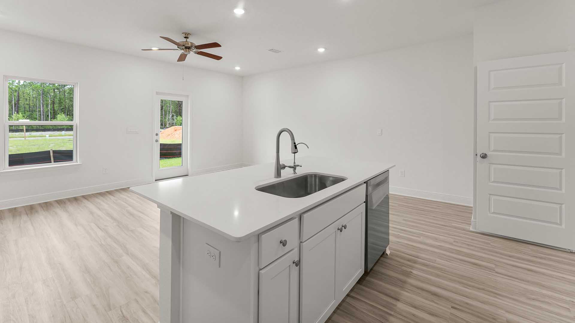 The center island has a sink and dishwasher with lower cabinetry allowing for easy meal prep and clean up