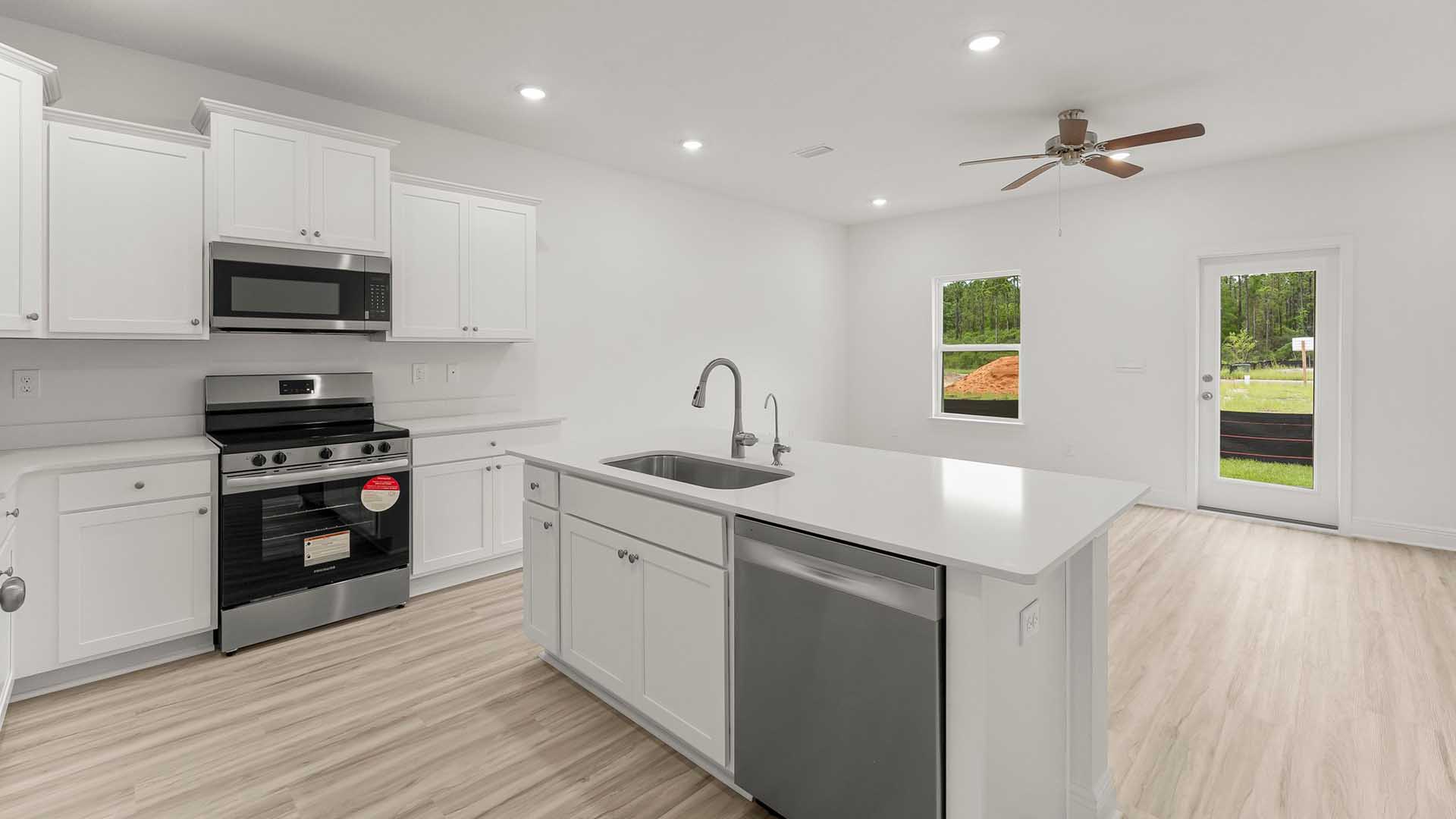 Half bath on the main level has a single vanity with lower cabinetry and quartz countertops