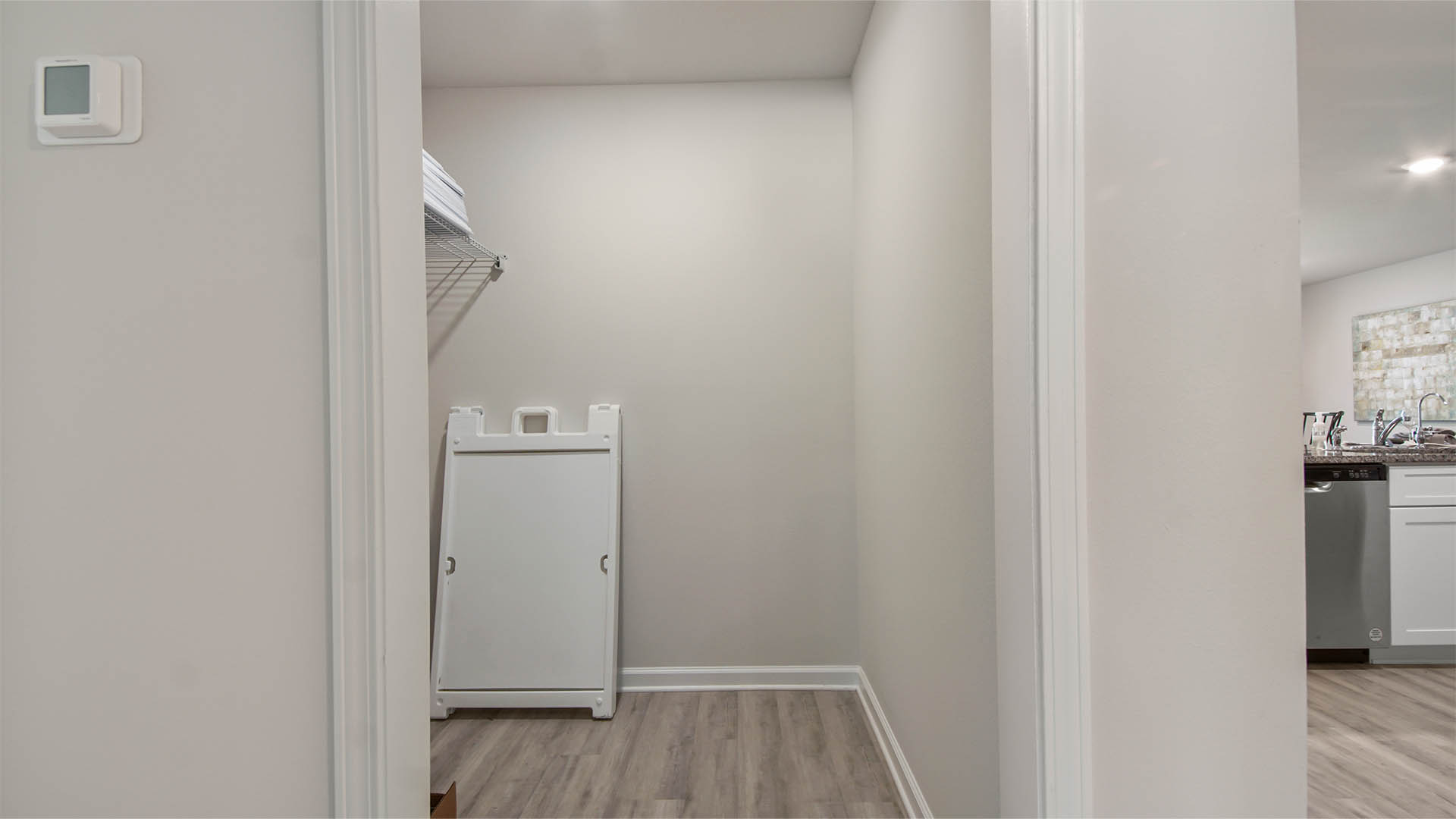 Spacious laundry room has EVP flooring and has space for full size washer and dryer