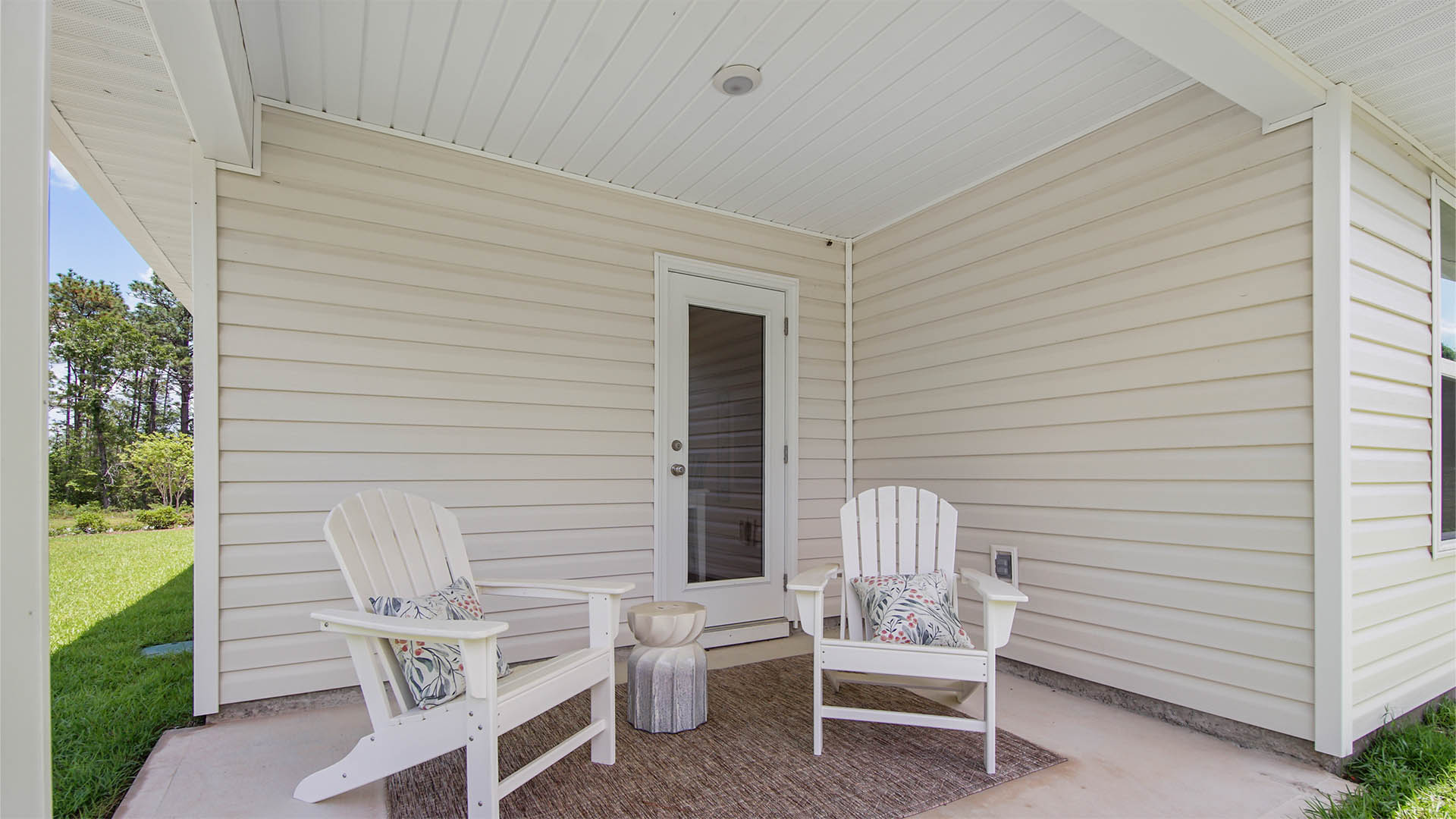 Covered porch at the rear of home is accessible from the dining room