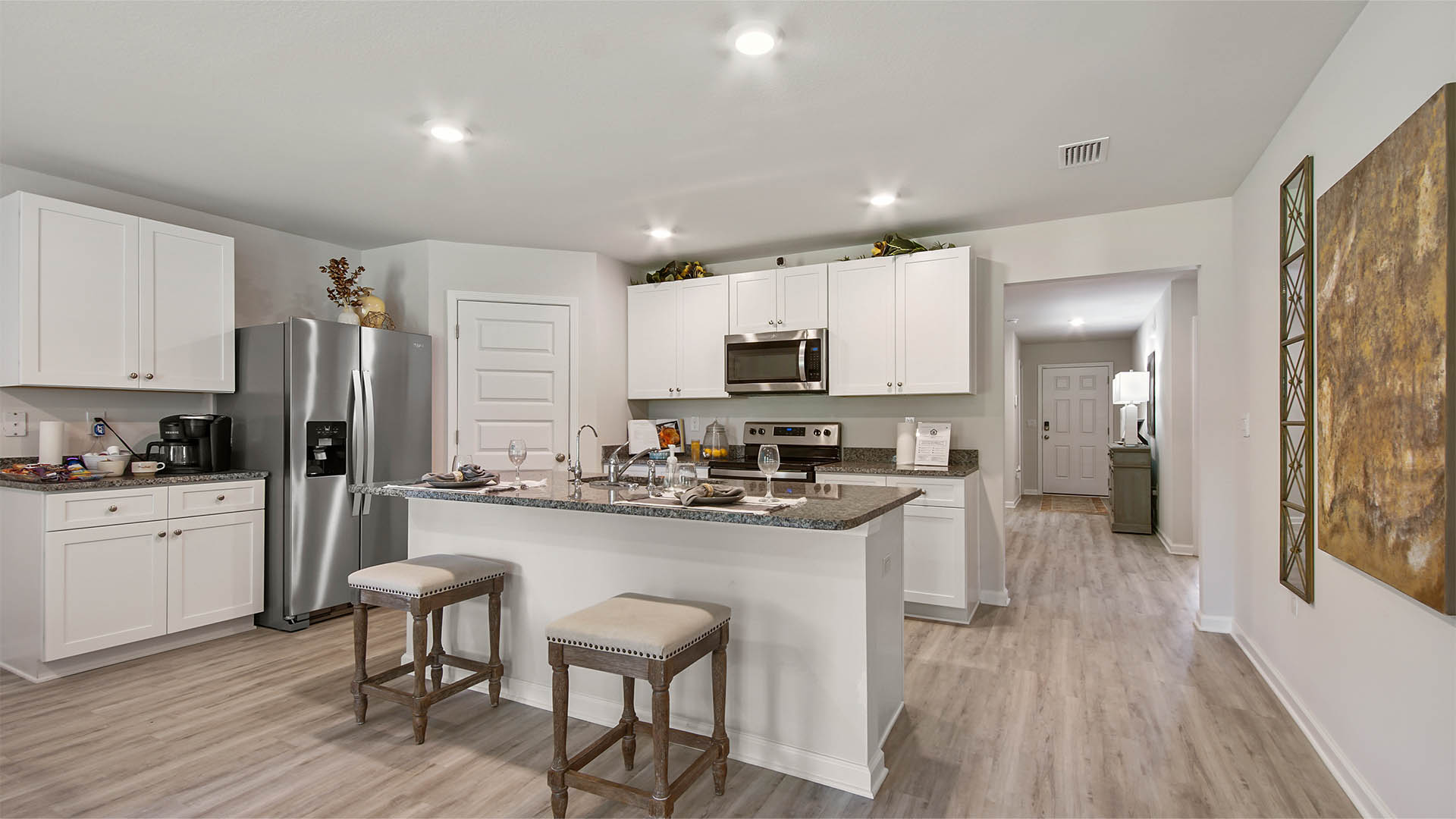 Spacious kitchen features upper and lower cabinetry and stainless appliances including a stove microwave and dishwasher