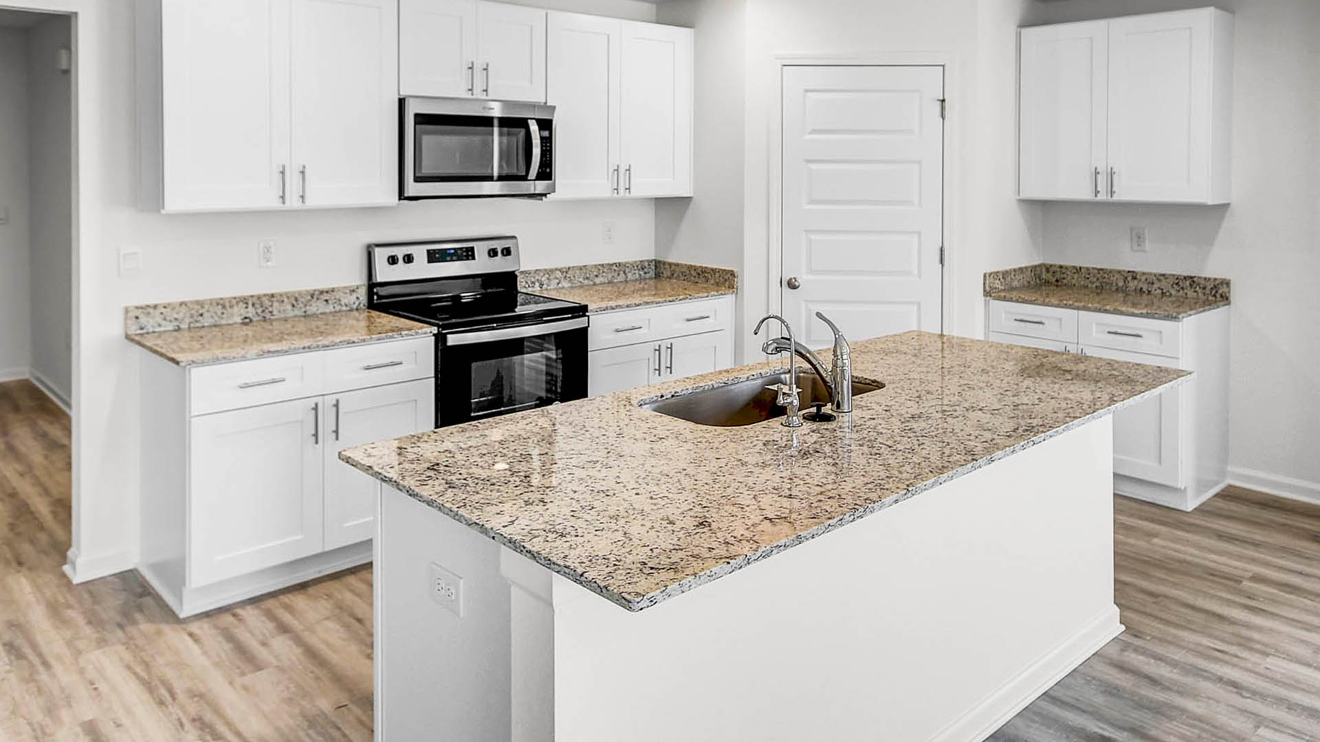 The kitchen features a center island with sink and dishwasher