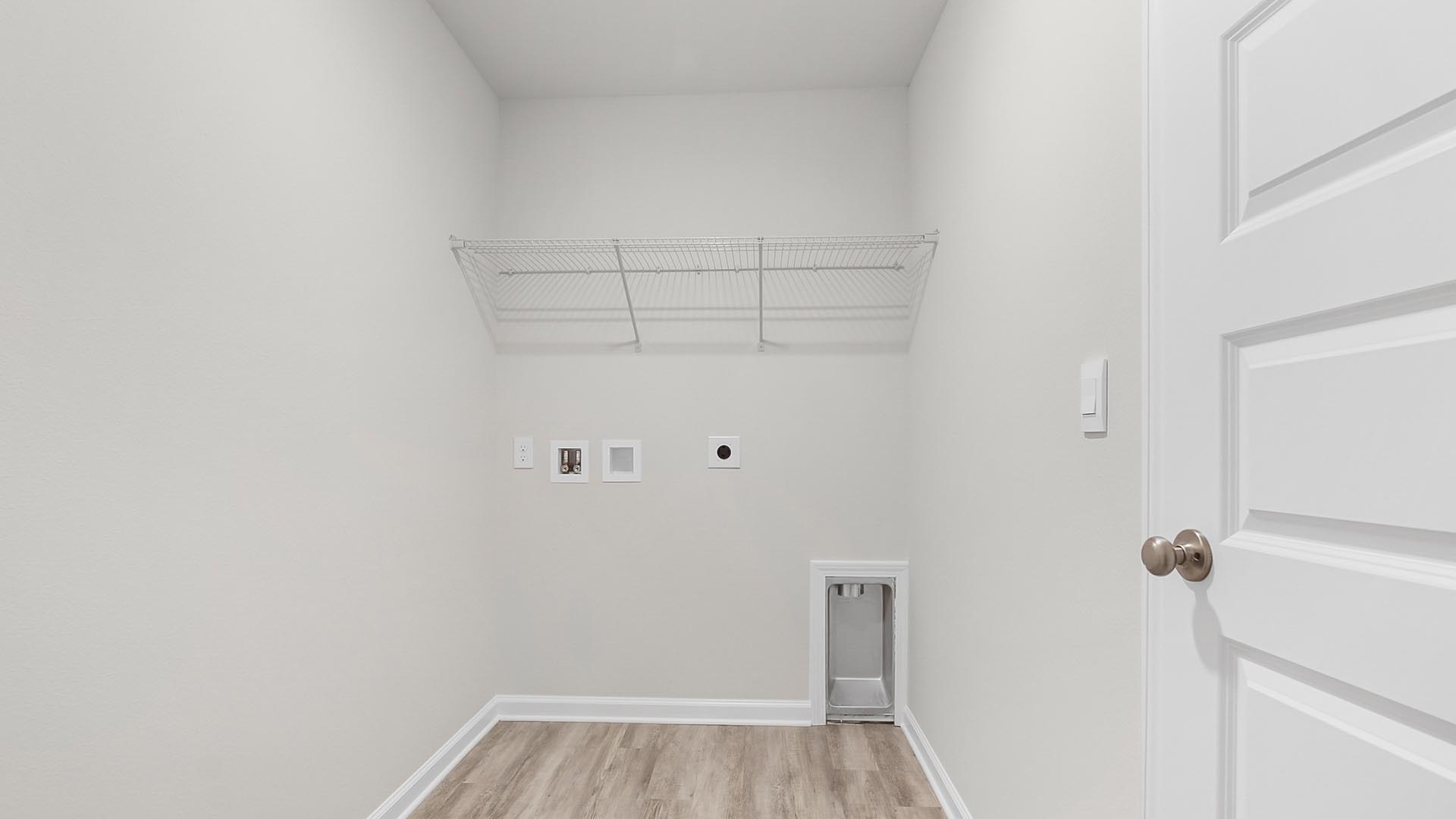 The laundry room has space for a full size washer and dryer