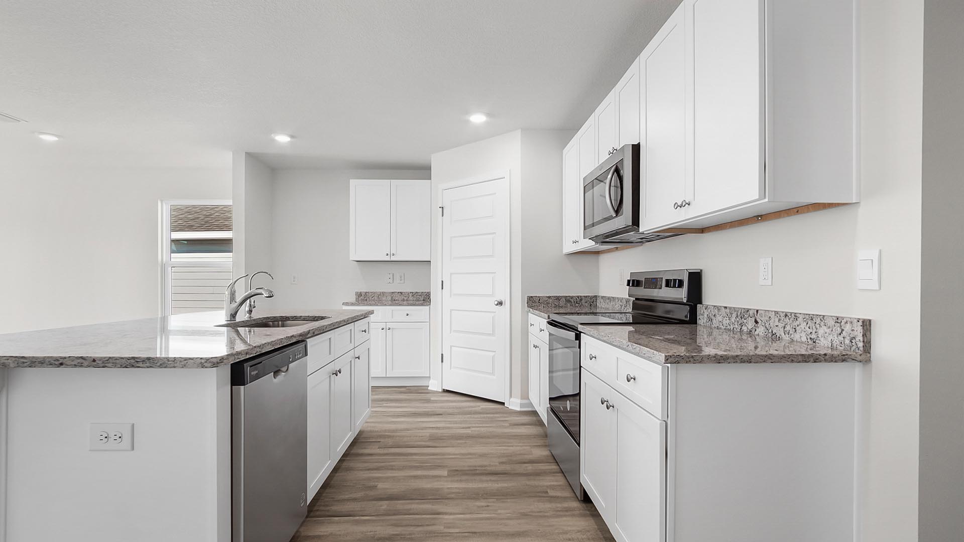 The kitchen has plenty of upper and lower cabinetry for storage