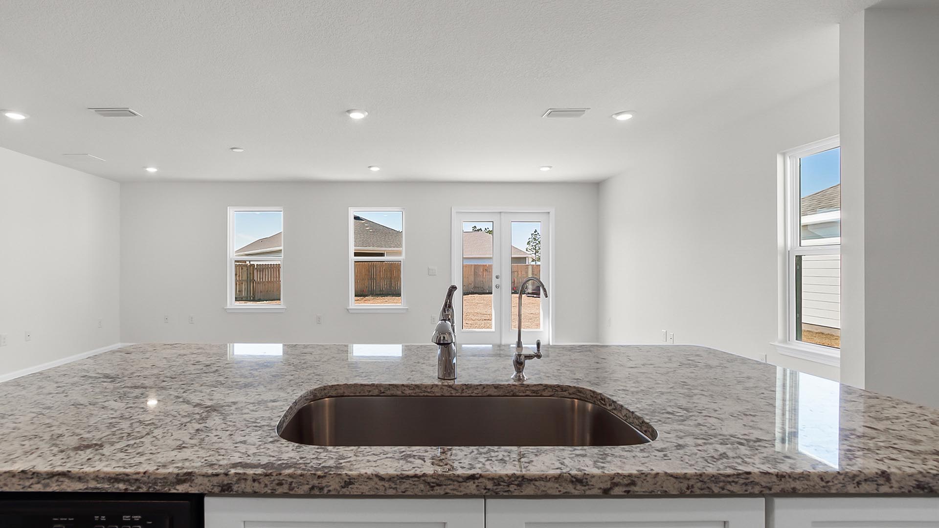 The kitchen overlooks the spacious living and dining area