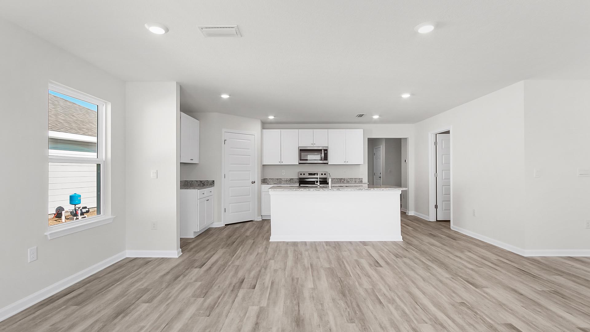 The spacious living area features EVP flooring