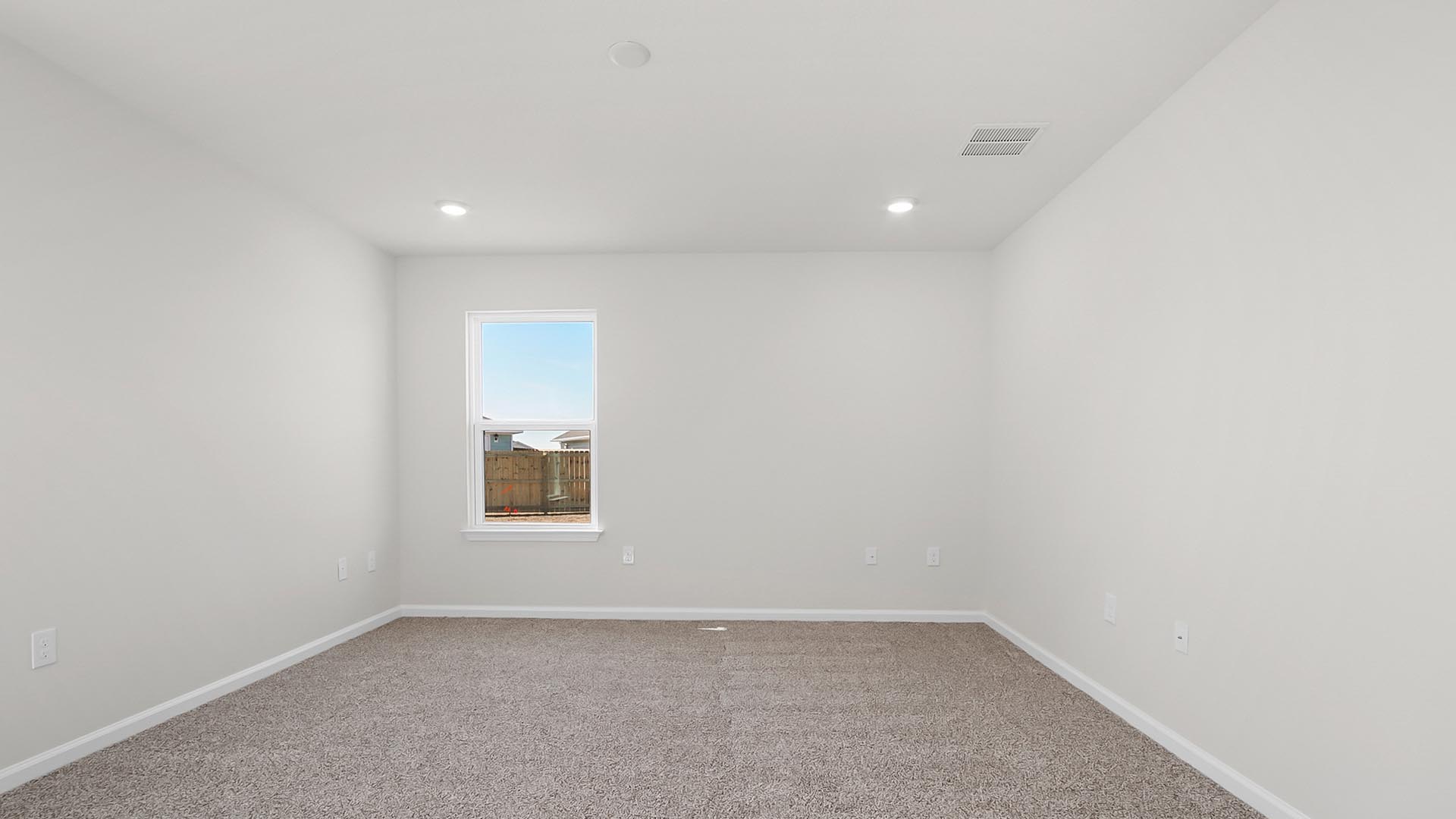 The primary bedroom is located at the back of the home for privacy