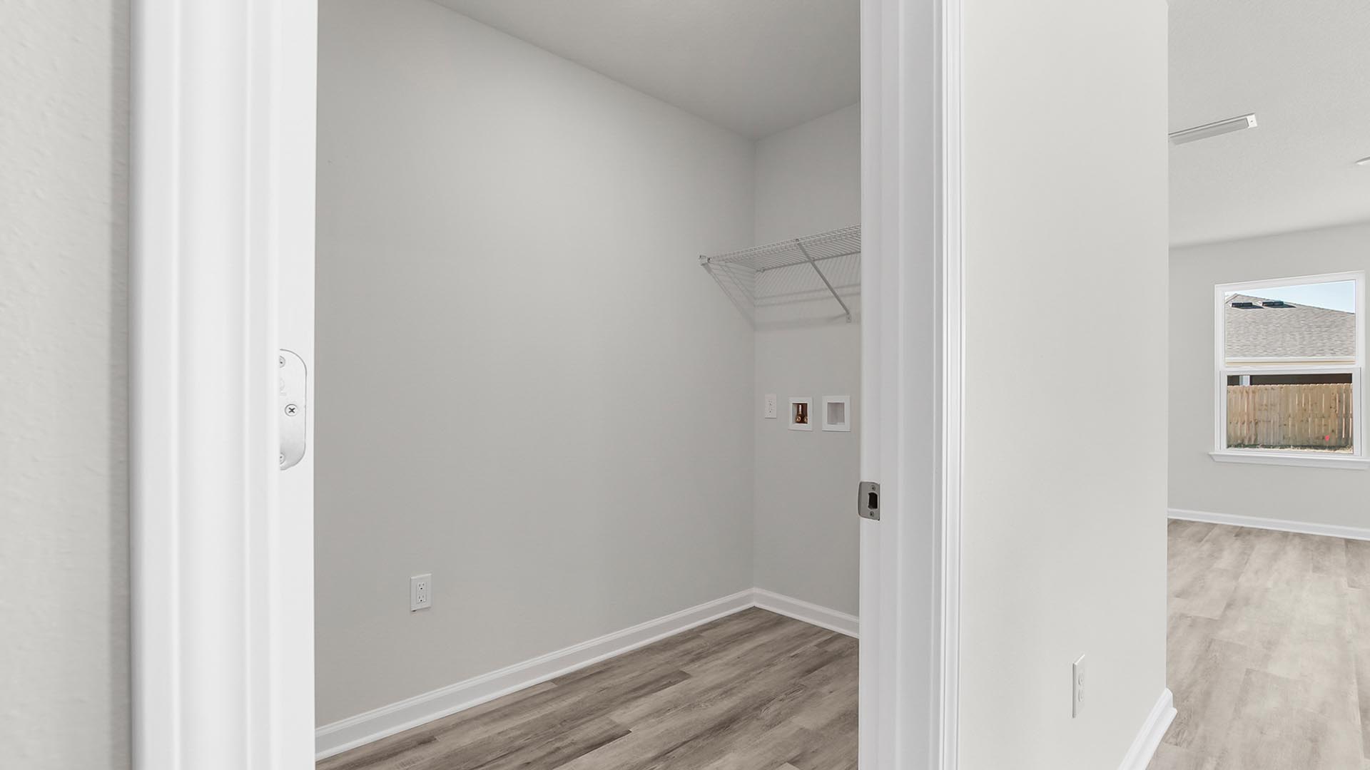 The laundry room is located off the living area and kitchen