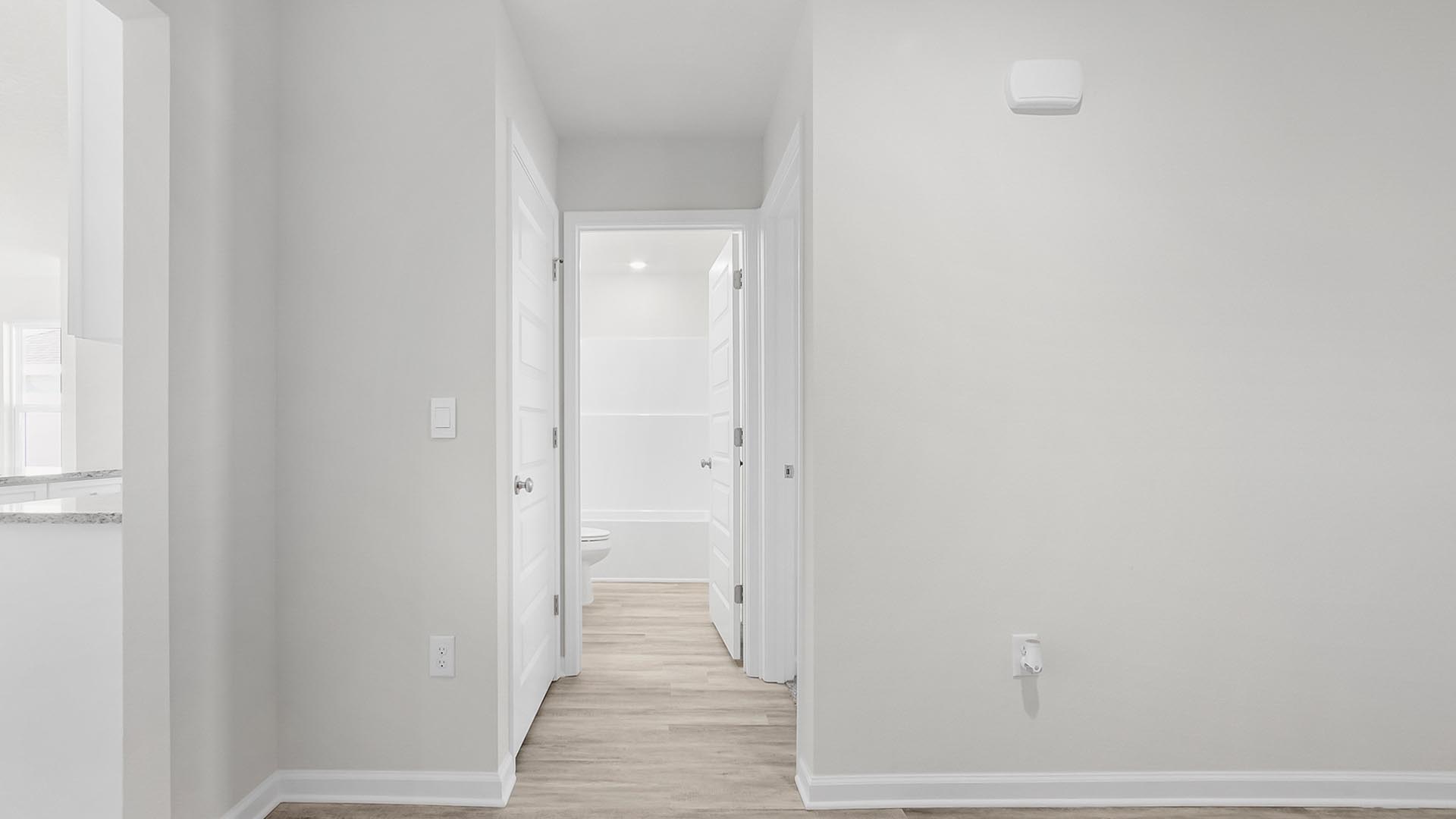 Hall to bedroom two and shared bathroom