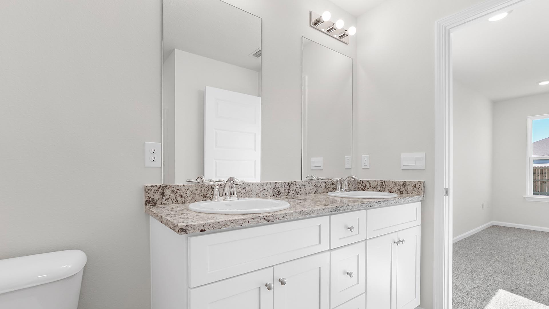 The primary bathroom has a double sink vanity