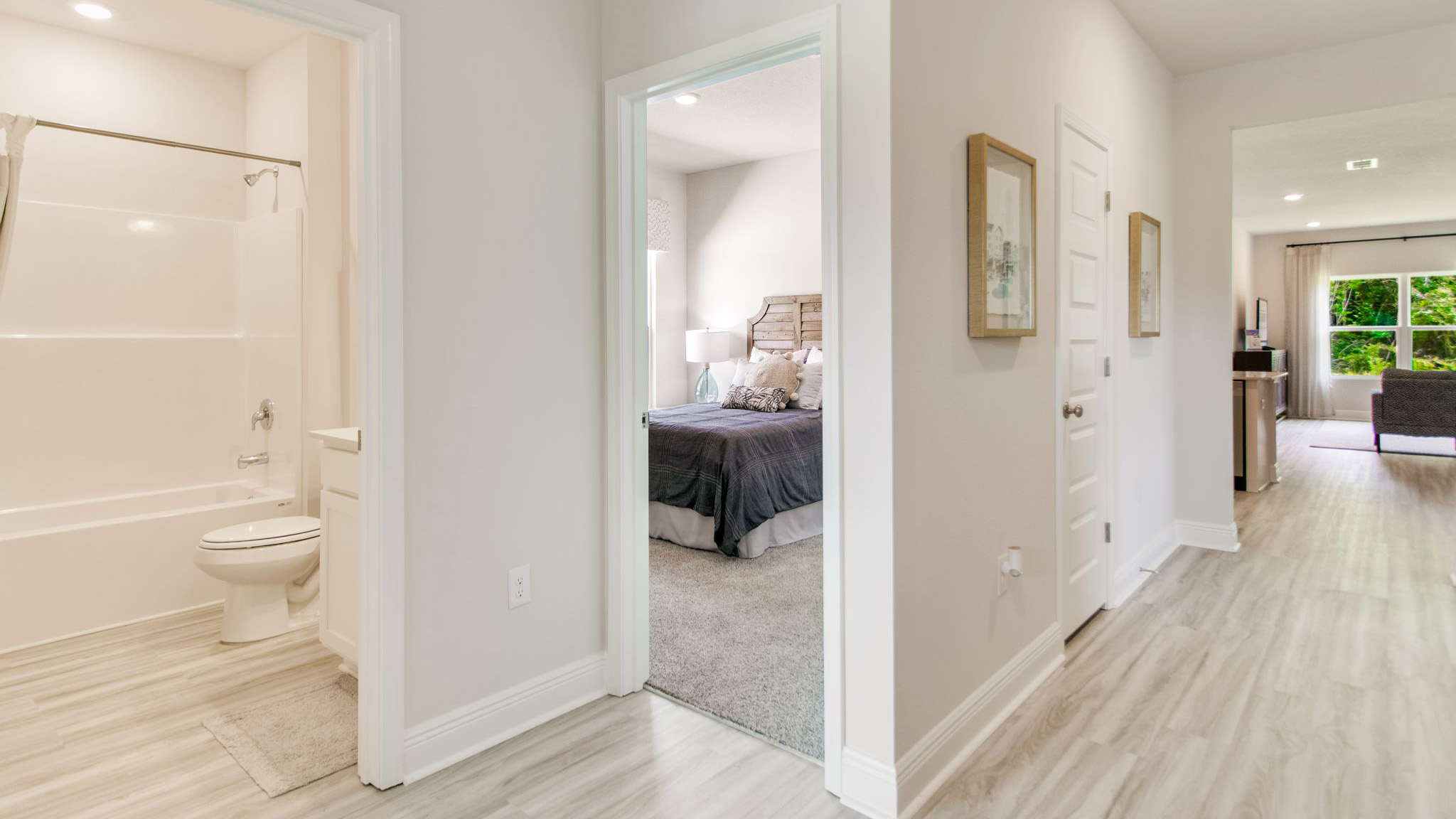 Two bedrooms are on one side of the entry hall and separated by the full bathroom