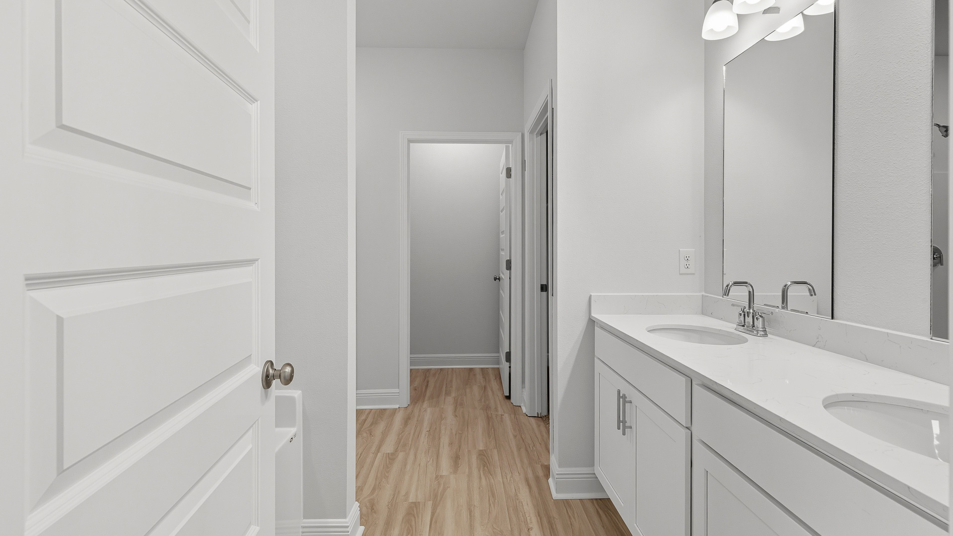There is a dual sink vanity in the primary bathroom with quartz countertops