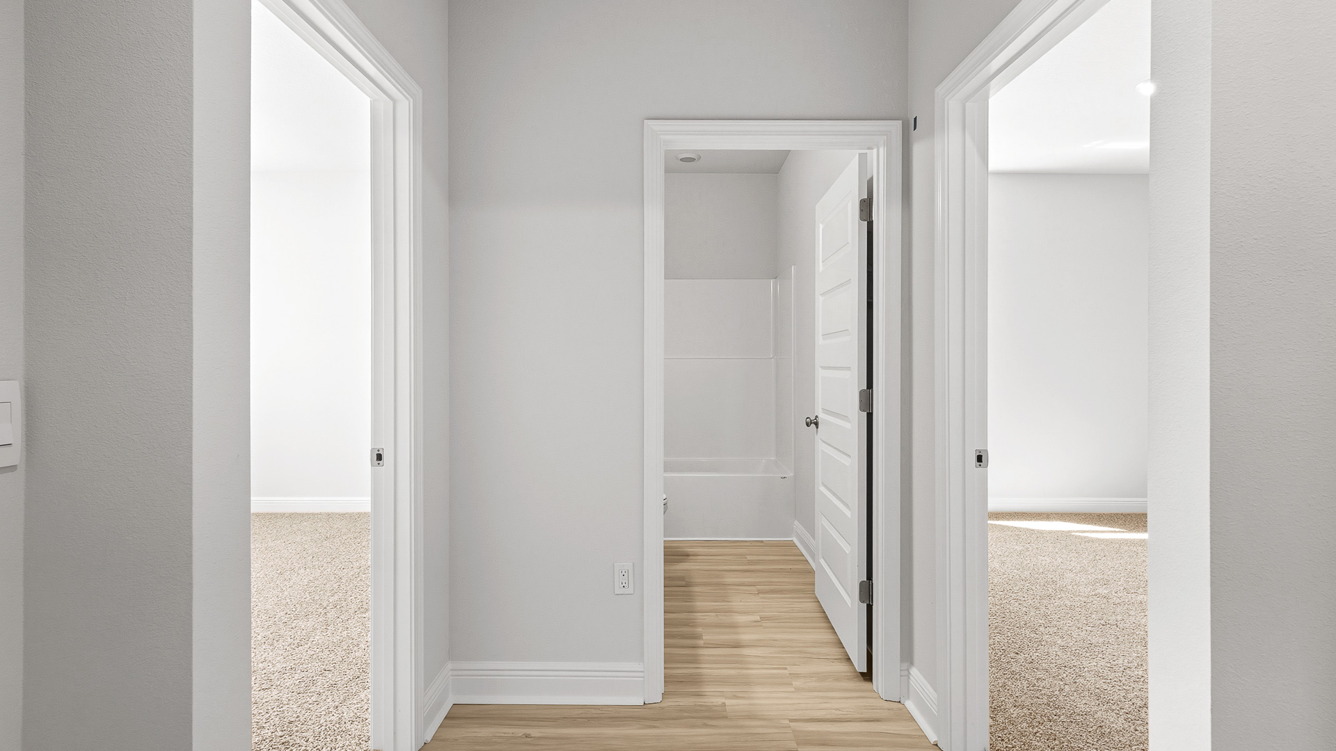 There is a hall adjacent to the dining area that holds bedrooms two and three