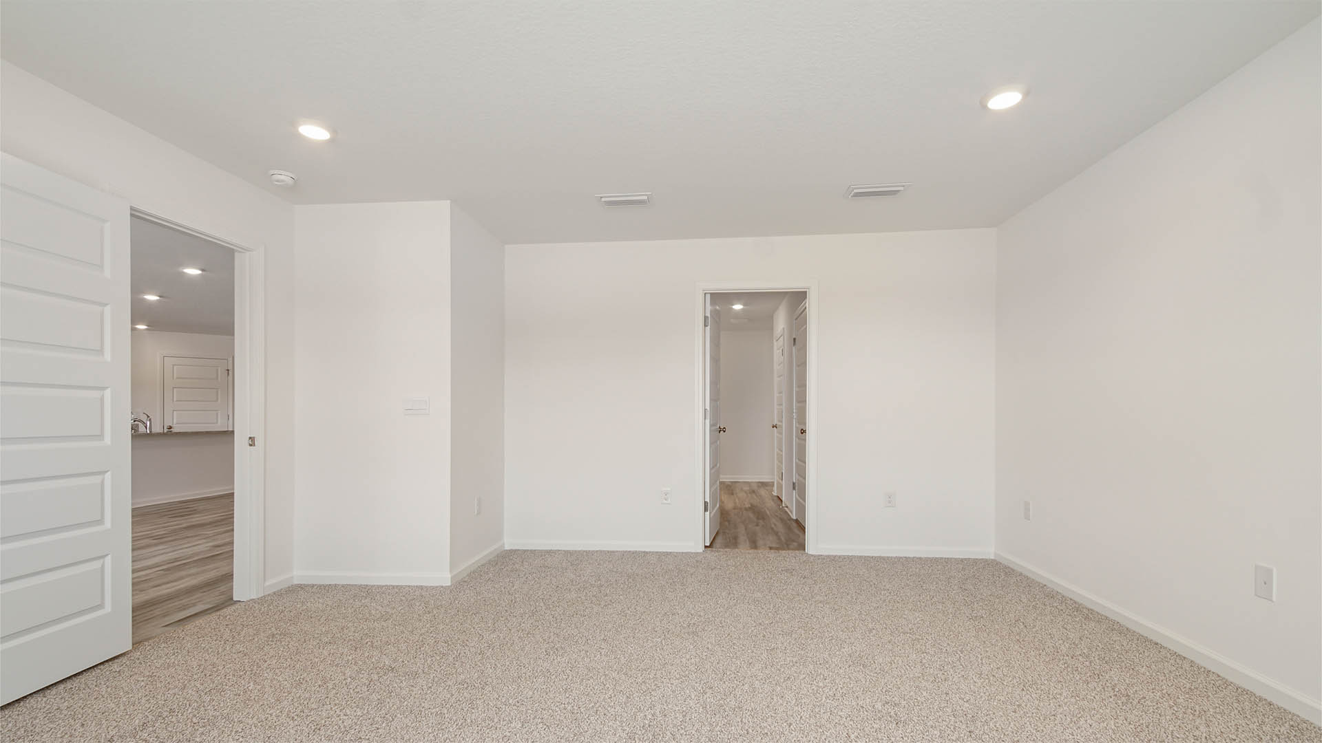 Primary bedroom is located off the great room