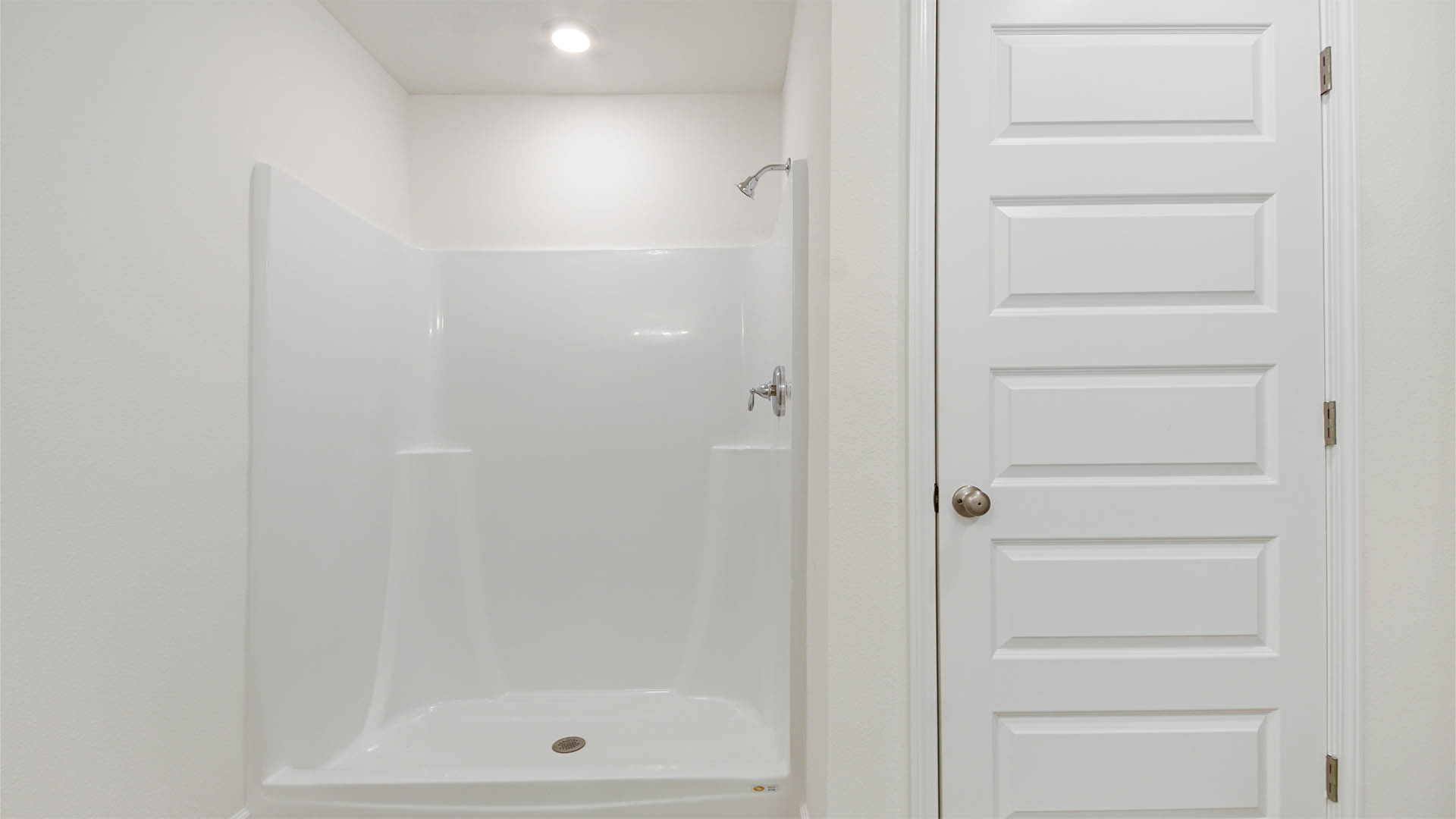 Primary bathroom has a vanity with quartz countertops and dual sinks