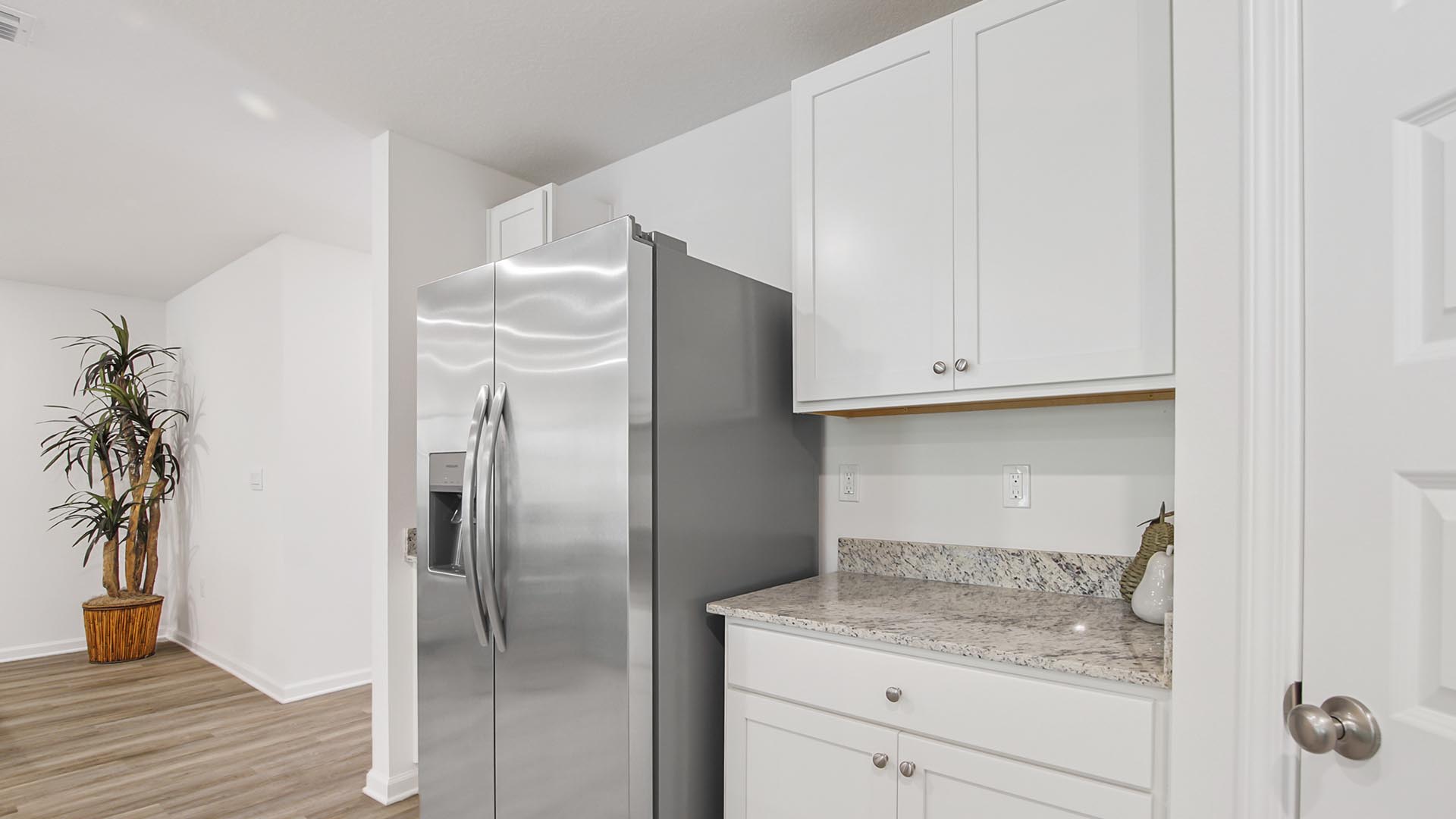 The kitchen features granite countertop and upper and lower cabinetry