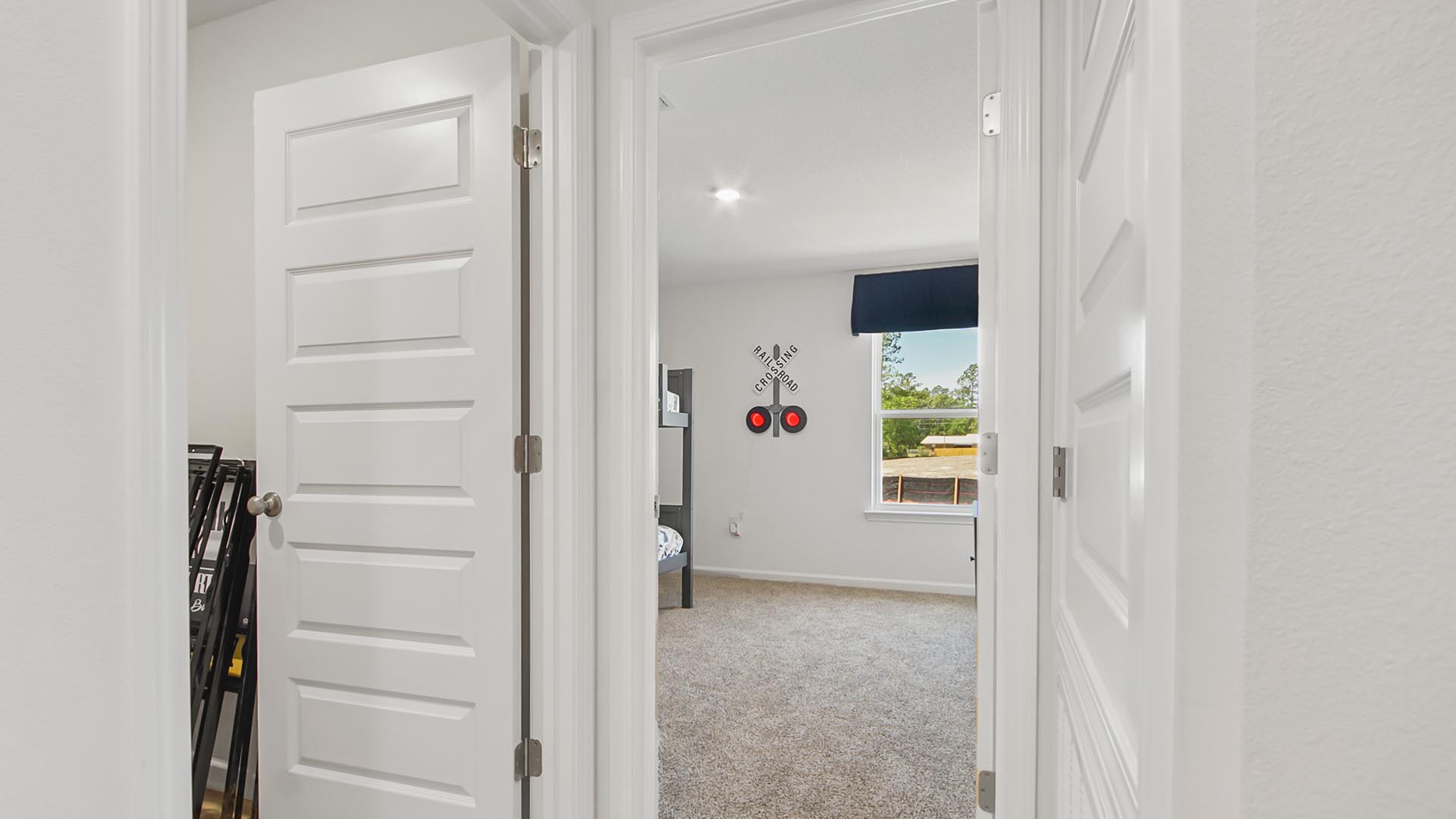 Hallway leading to bedroom four and the laundry room and garage
