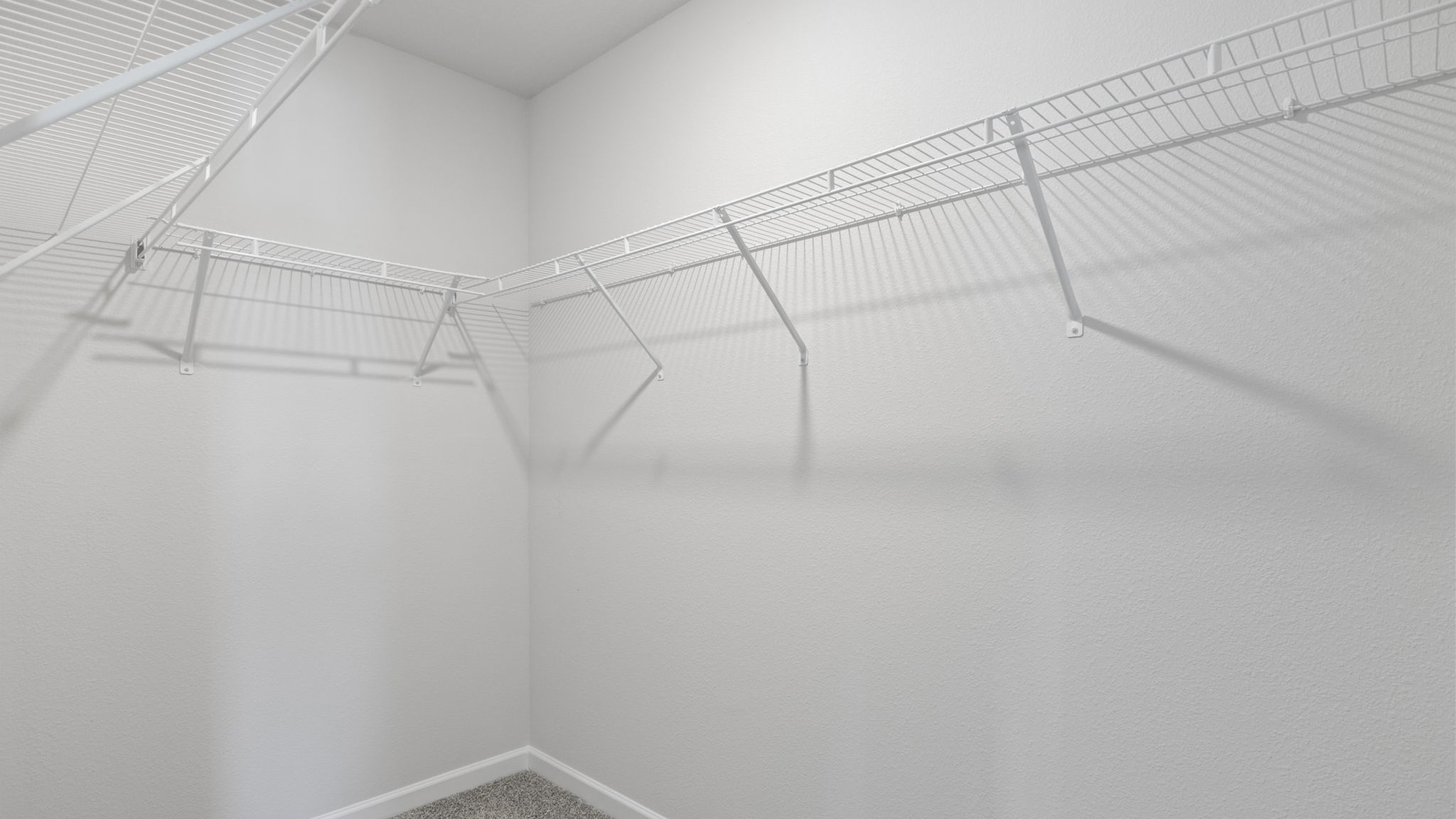 There is a walk in closet in the primary bedroom with upper shelf