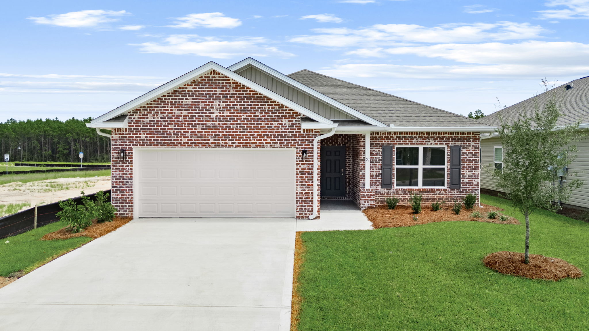 Example of the Walker floor plan at completion with brick front exterior and three sided vinyl construction