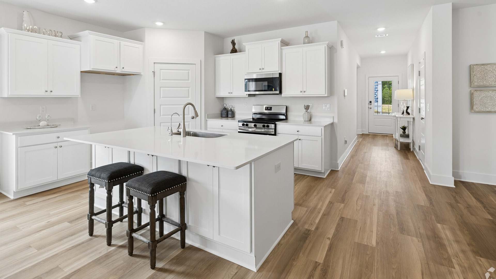 The Riverside has an open kitchen with center island and plenty of upper and lower cabinetry for storage