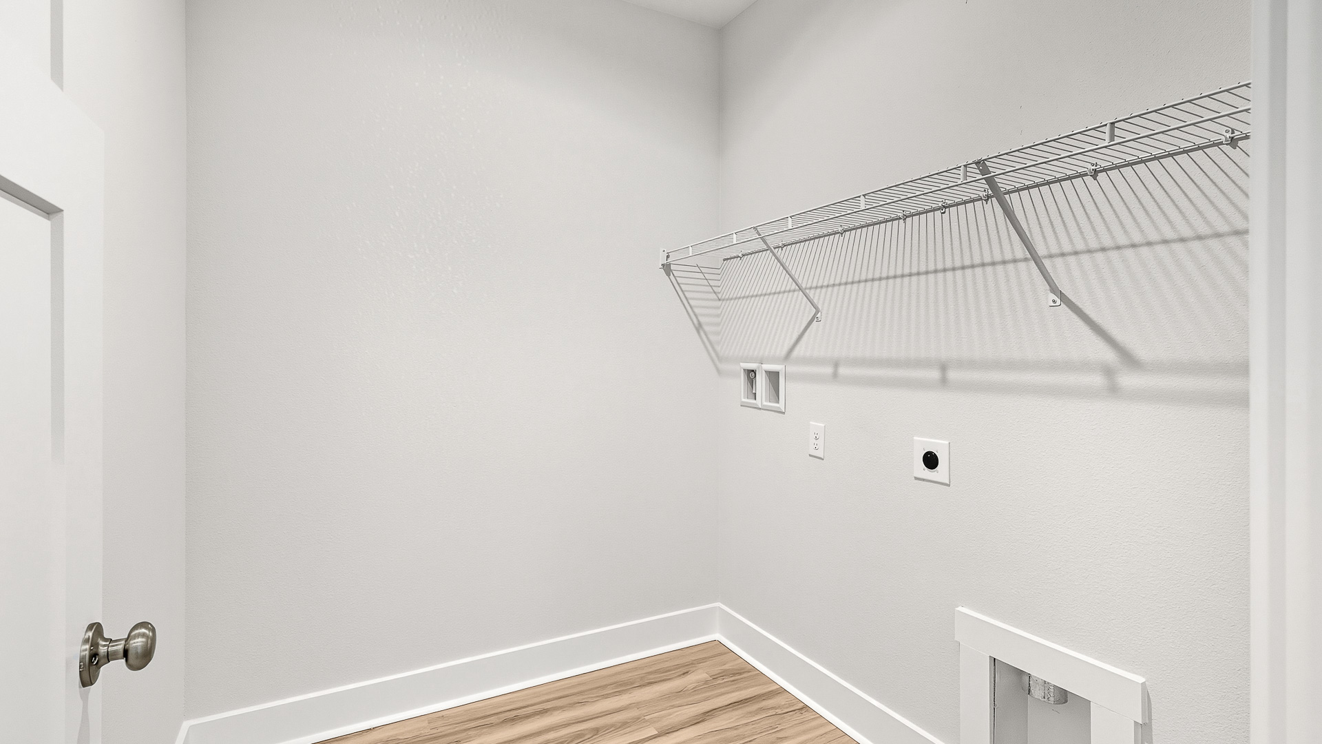 The laundry room has space for a full size washer and dryer