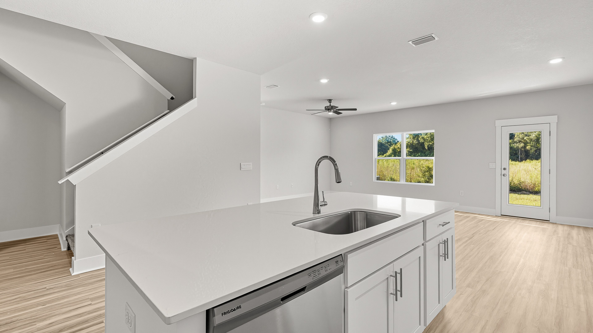 The kitchen opens to a dining and living area