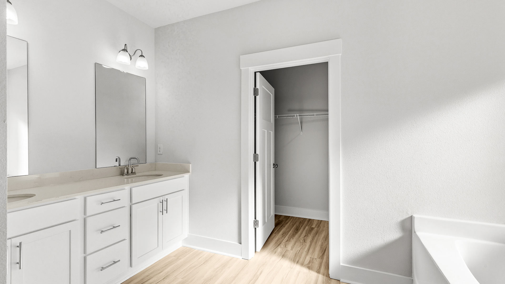 The primary bathroom has a dual sink vanity