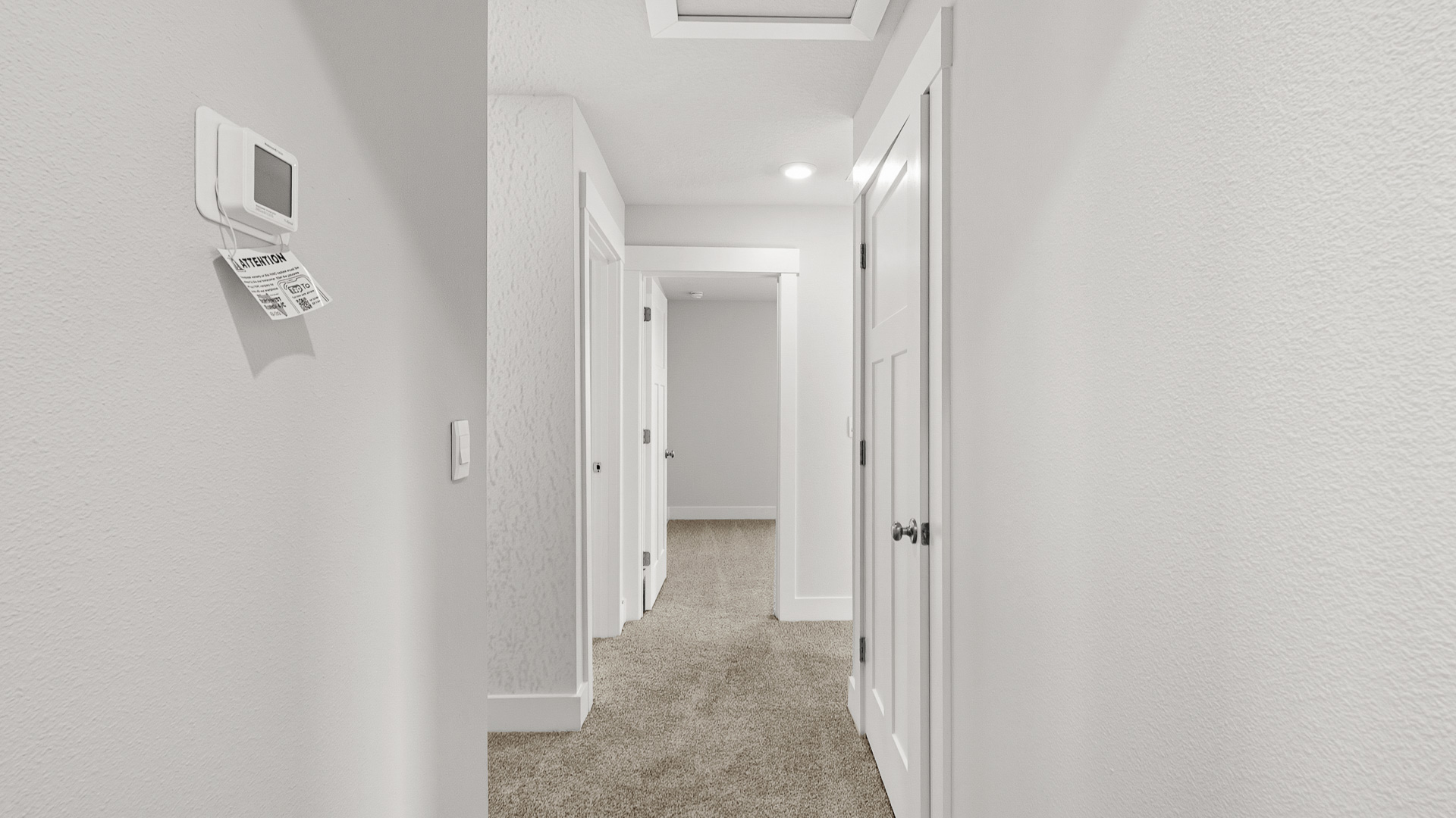 There is a hall that leads from the living area on second level to three guest bedrooms