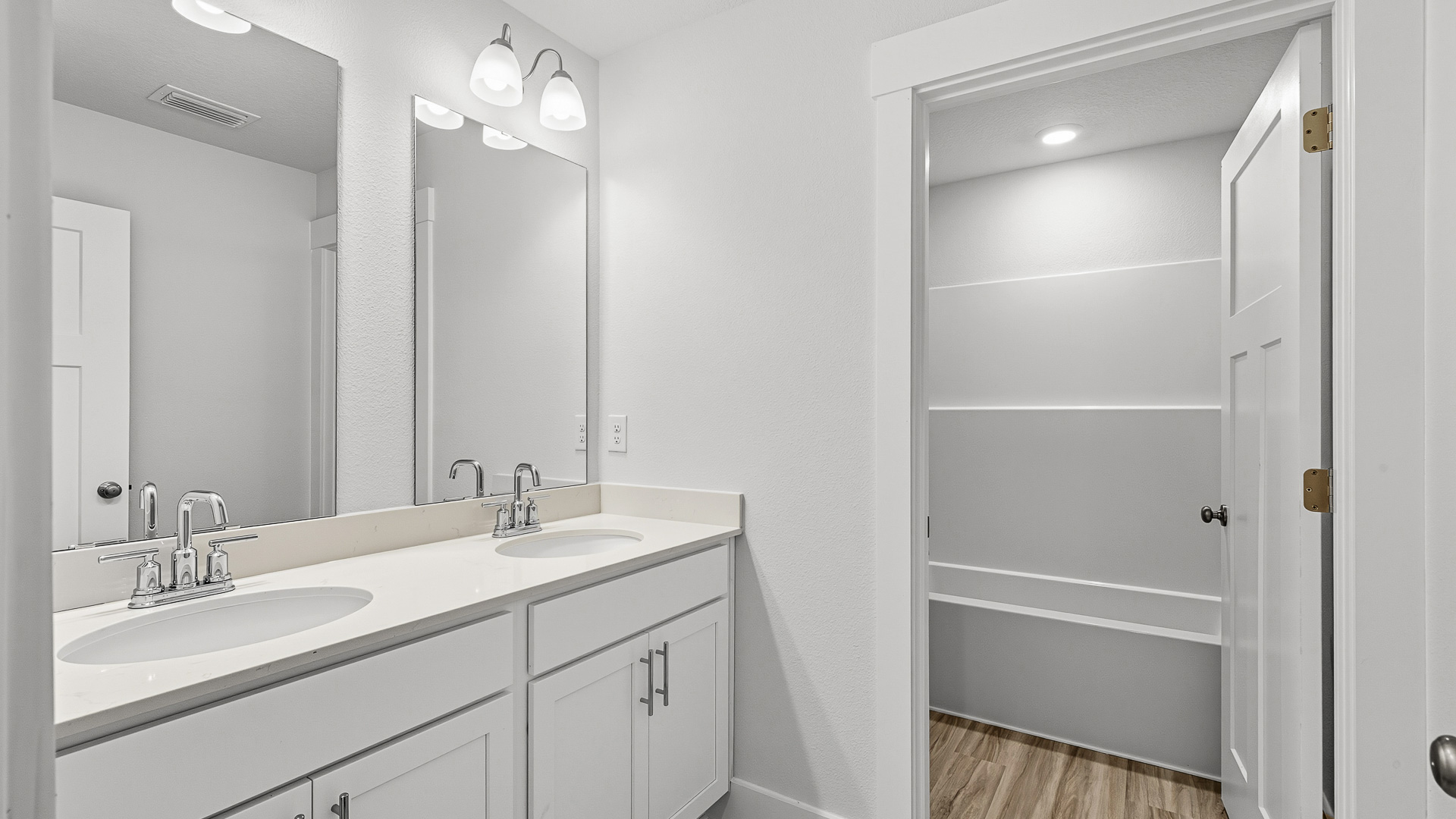 Three of the guest bedrooms share a full bath with vanity and shower tub combination