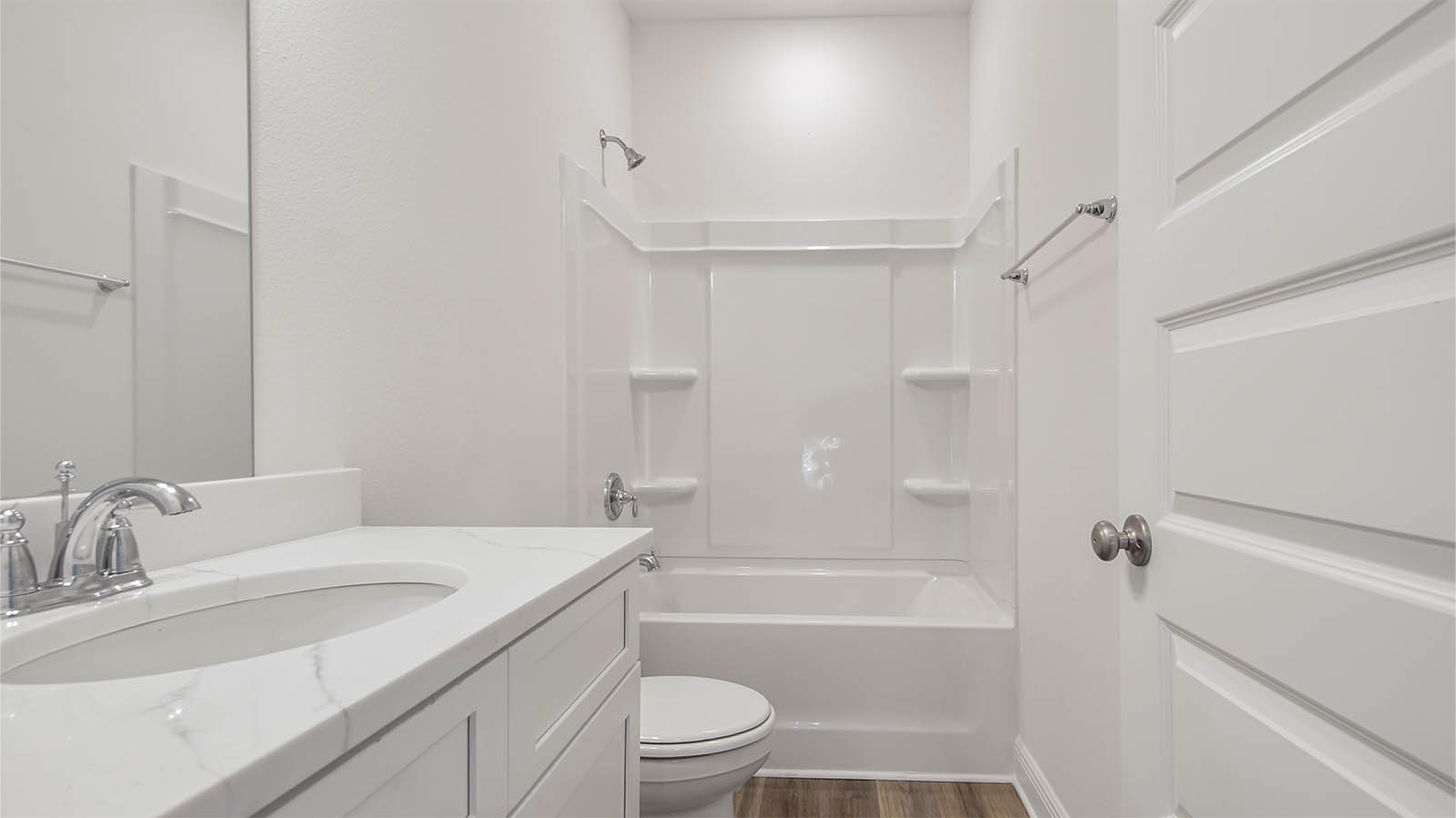 Shared bathroom with a shower tub combo and EVP flooring and single vanity with quarts countertops.