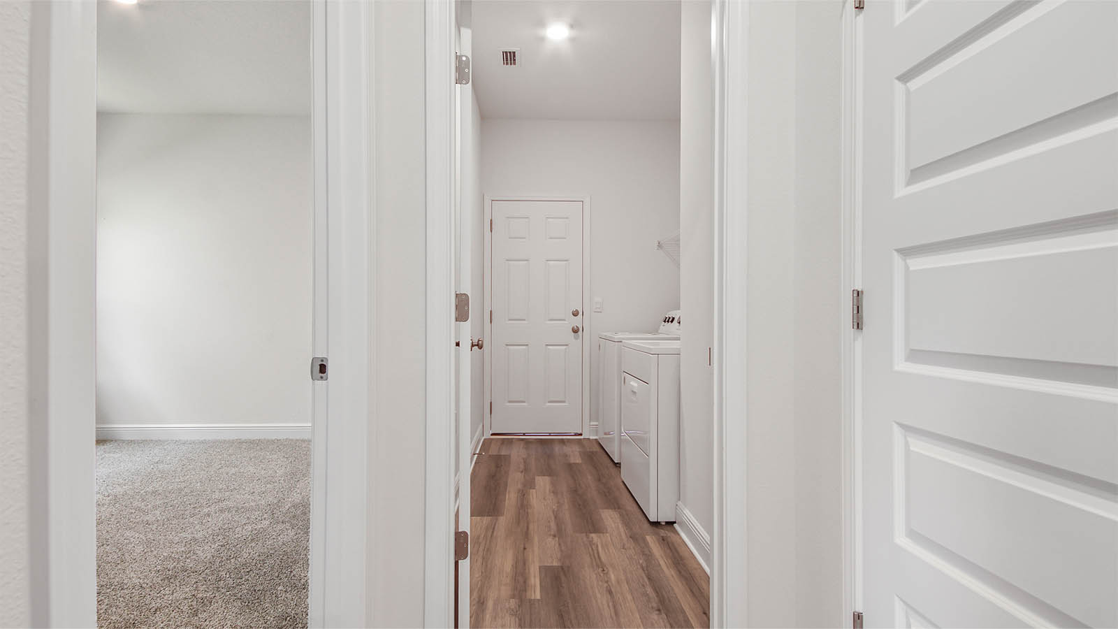 A laundry room is located off the hall near bedrooms two and three