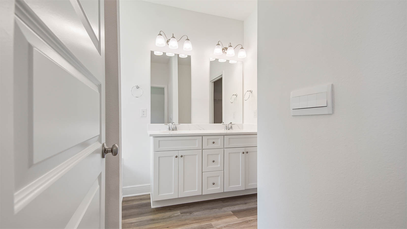 Primary bathroom with large soaking tub below a frosted glass window and a separate standing shower.