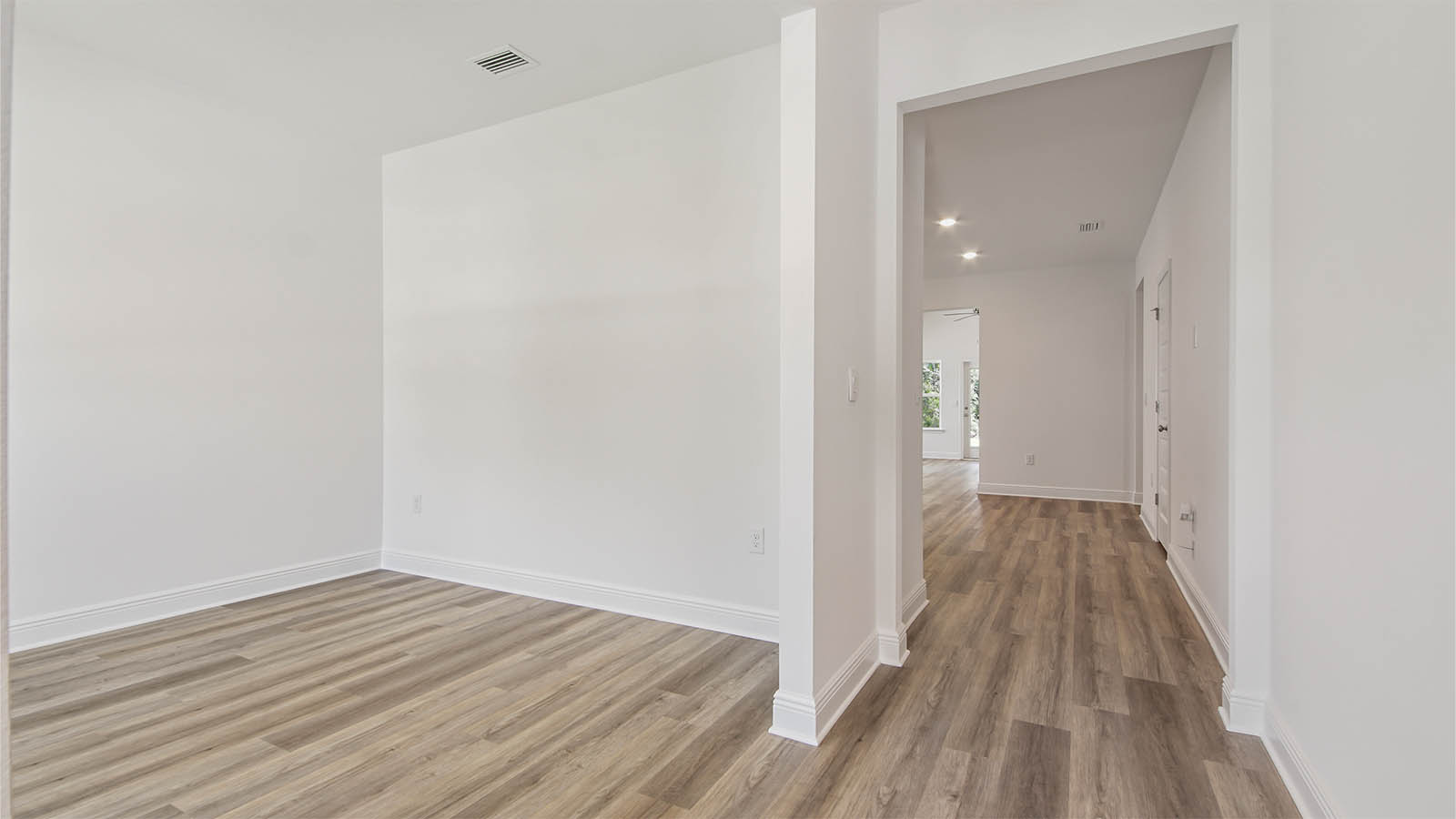 Foyer with EVP flooring and flex space for an office or formal dining room.