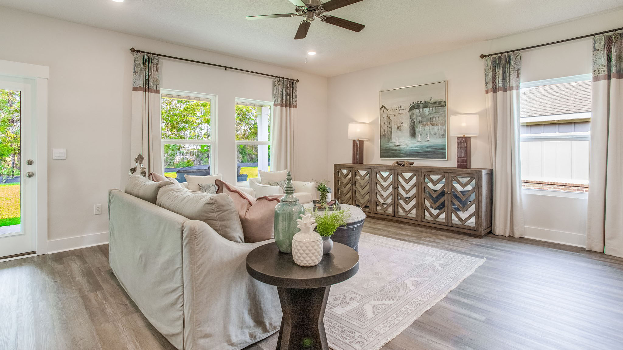 The spacious living room offers space for a sofa, chairs, end table and entertainment center